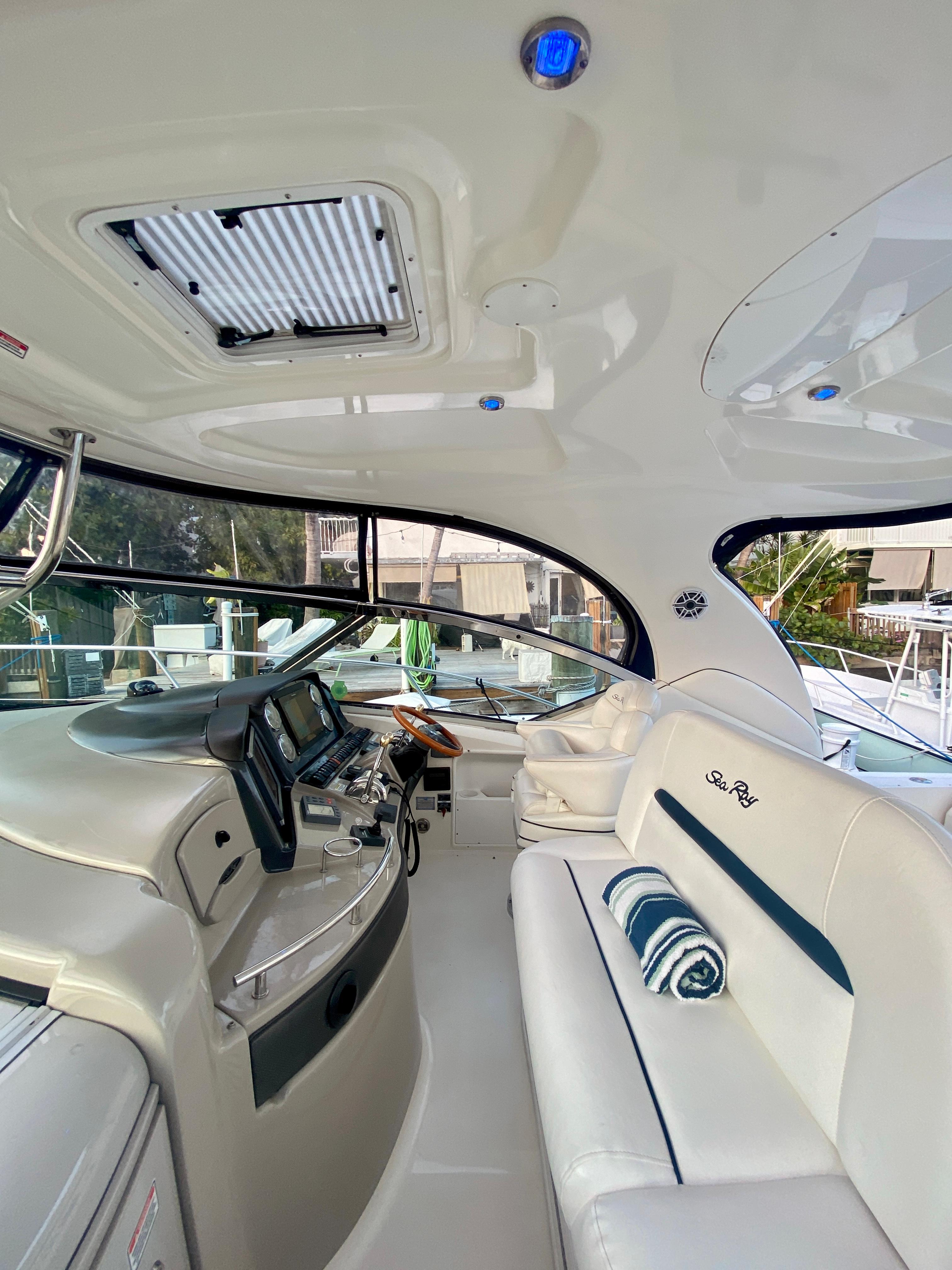 2005 Sea Ray 420 Sundancer interior with helm and seating area.