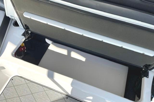 2021 Yamaha Boats 275SD storage compartment with open seat revealing interior space.