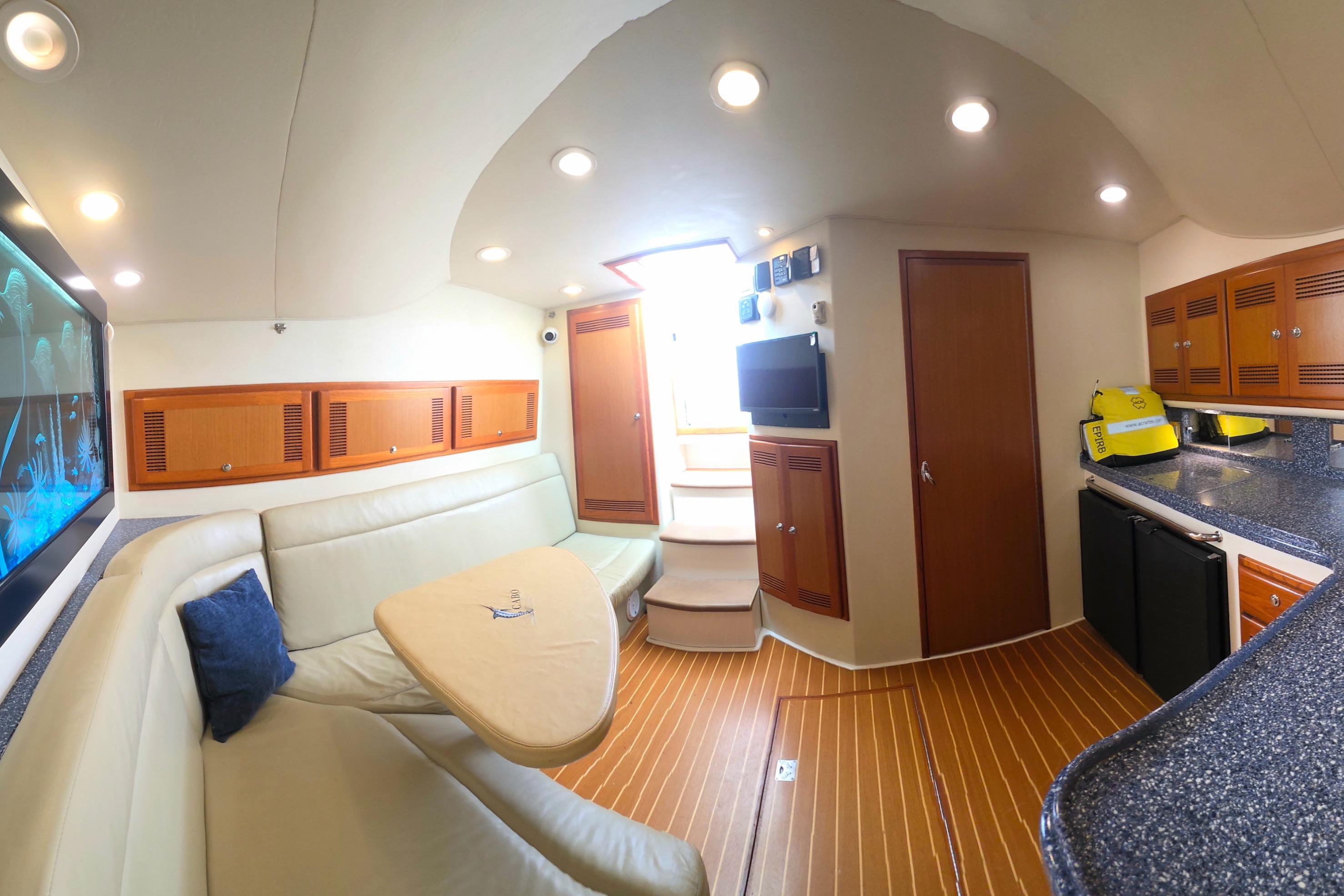 Interior of 2004 Cabo 40 Hardtop Express yacht with modern seating and kitchenette.