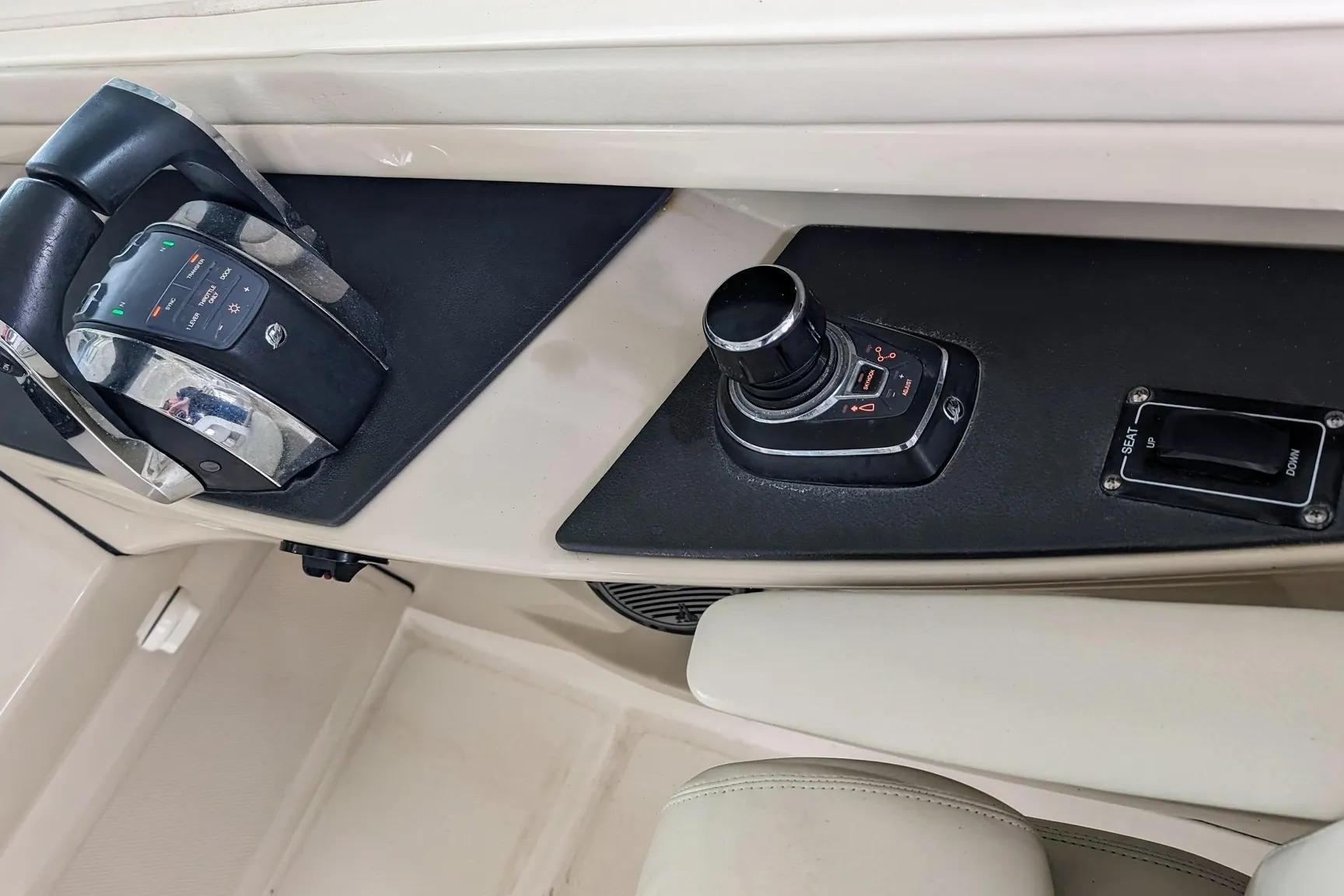 Control panel of a 2017 Boston Whaler 320 Vantage boat, featuring throttle and joystick controls.