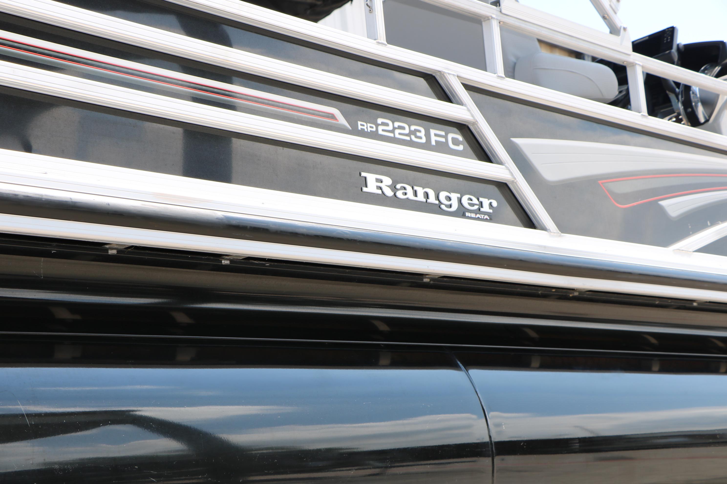 2021 Ranger 223FC boat exterior with sleek black and silver design.