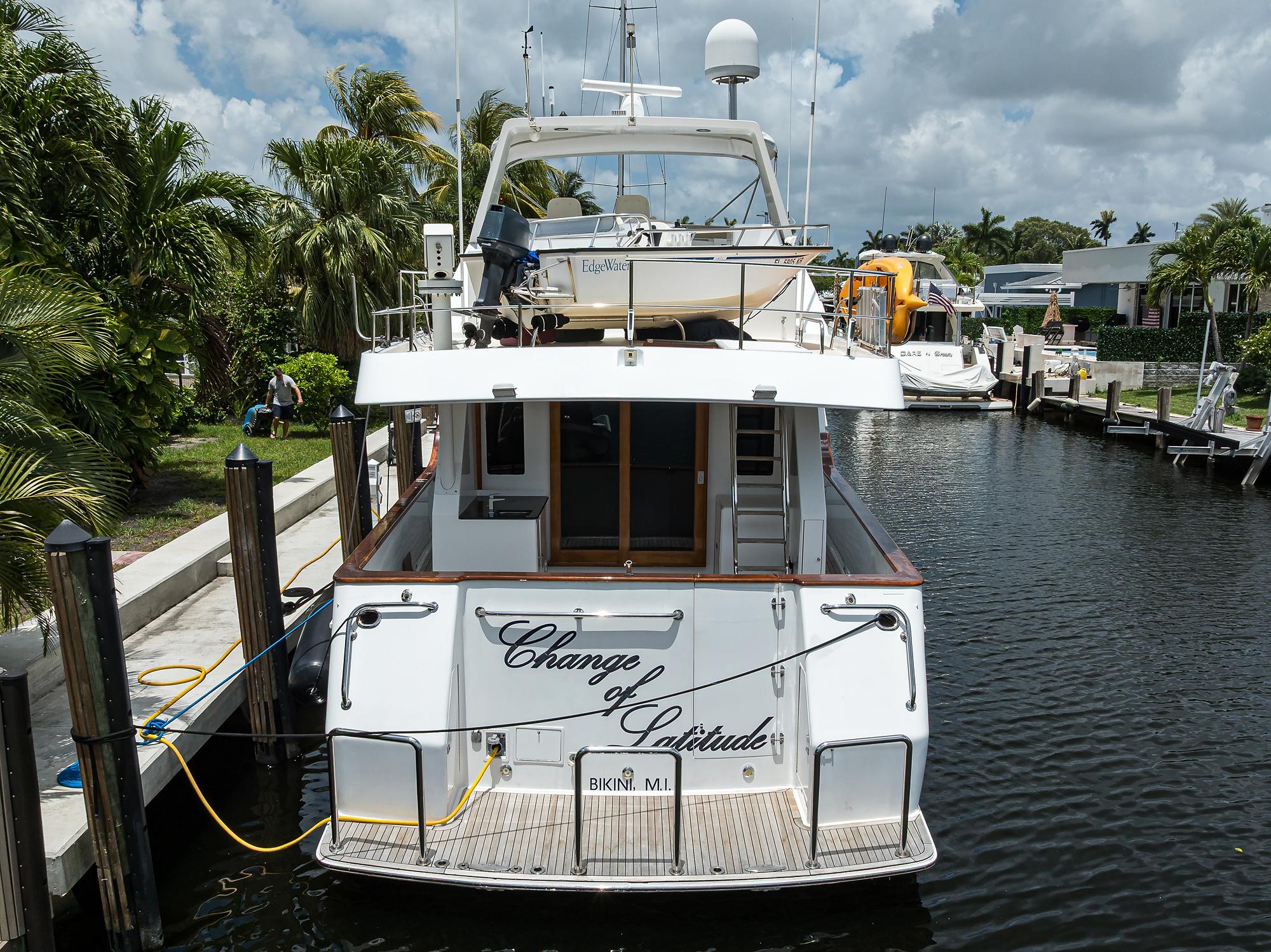 Ocean Alexander 602 yacht docked, rear view, "Change of Latitude," 2001 model, tropical setting.