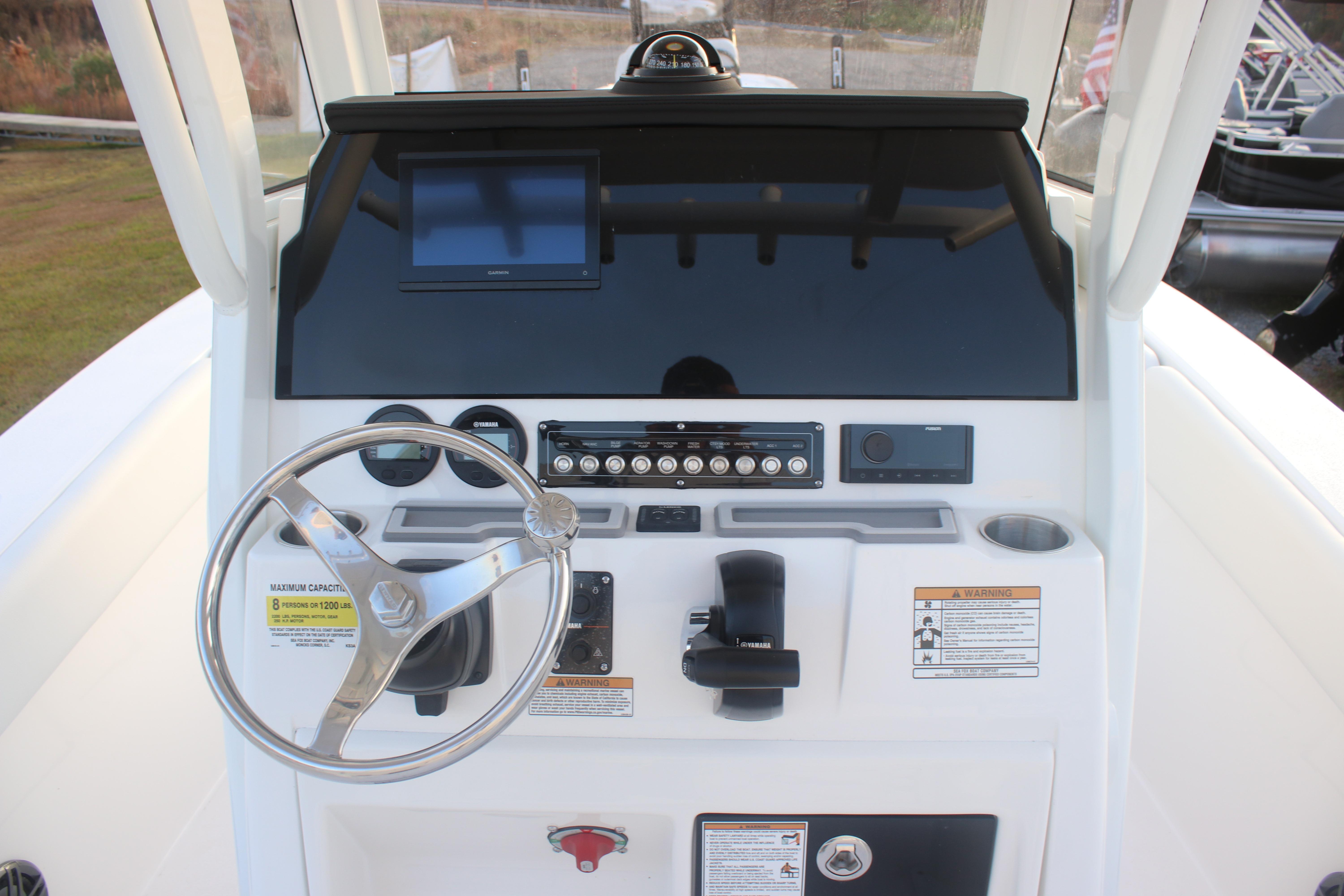 2026 Sea Fox 228 Commander boat console with steering wheel and control panel.