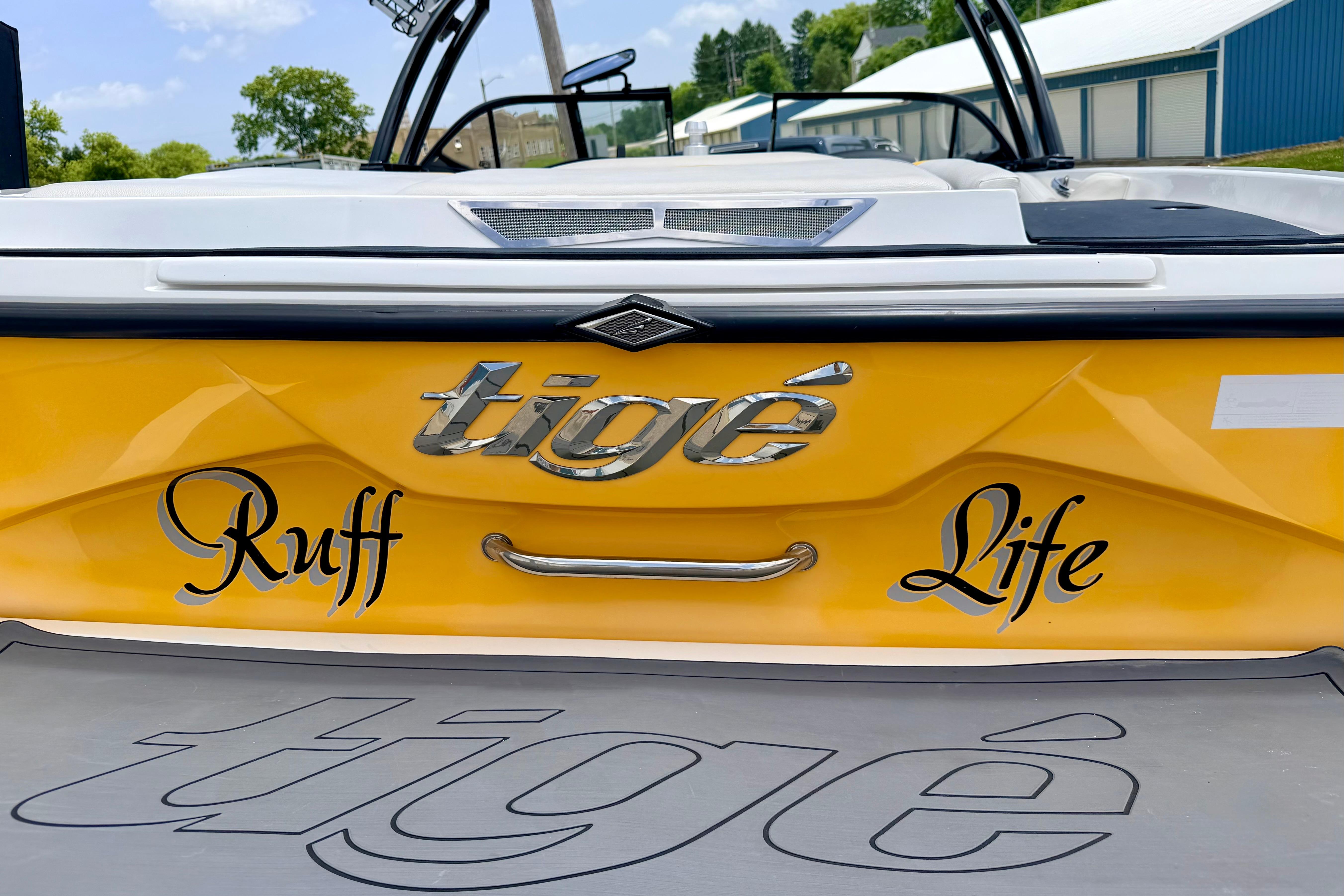 2014 Tigé R20 boat with "Ruff Life" decal on yellow hull.