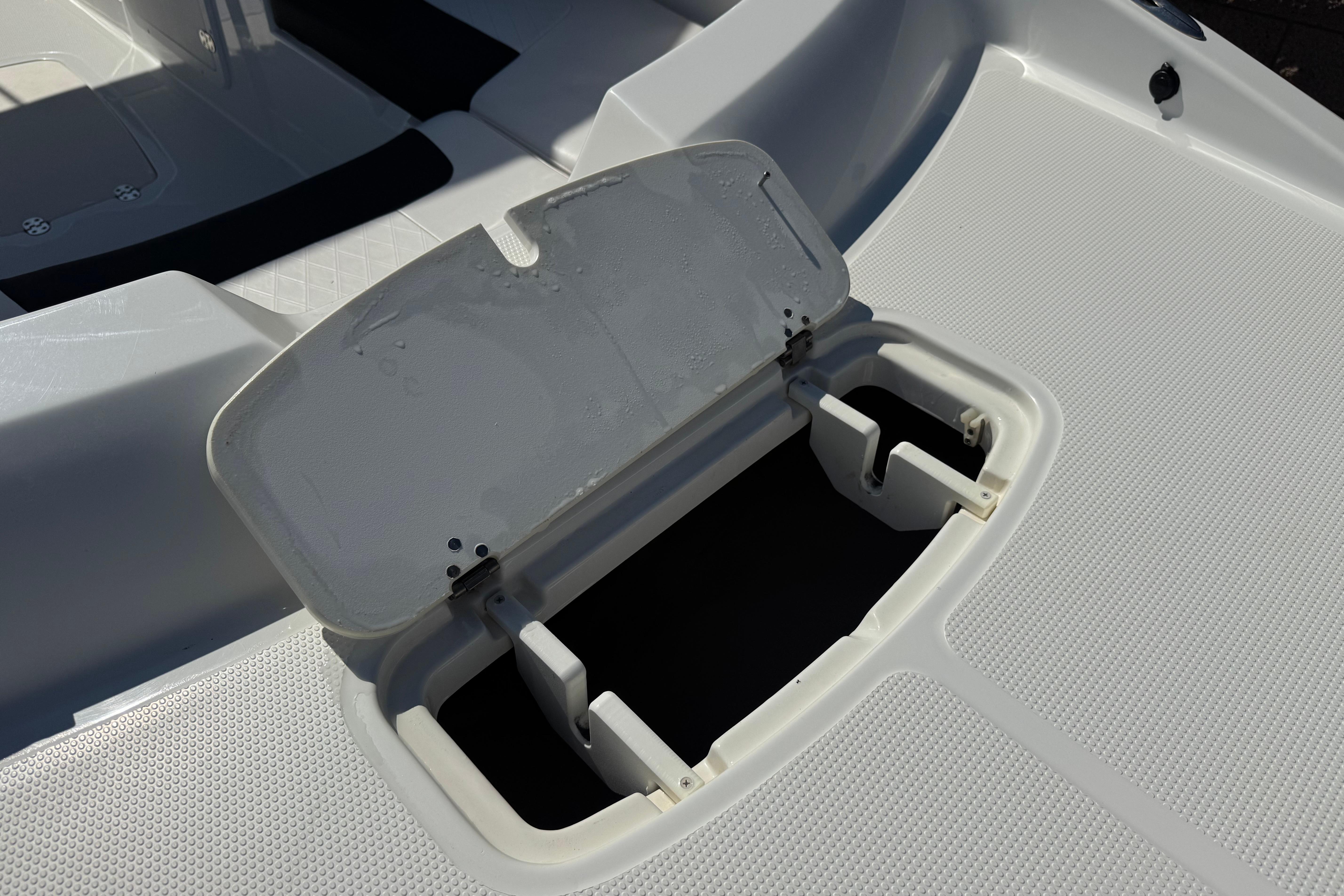 Open storage compartment on a 2019 Tahoe 2150 boat deck.