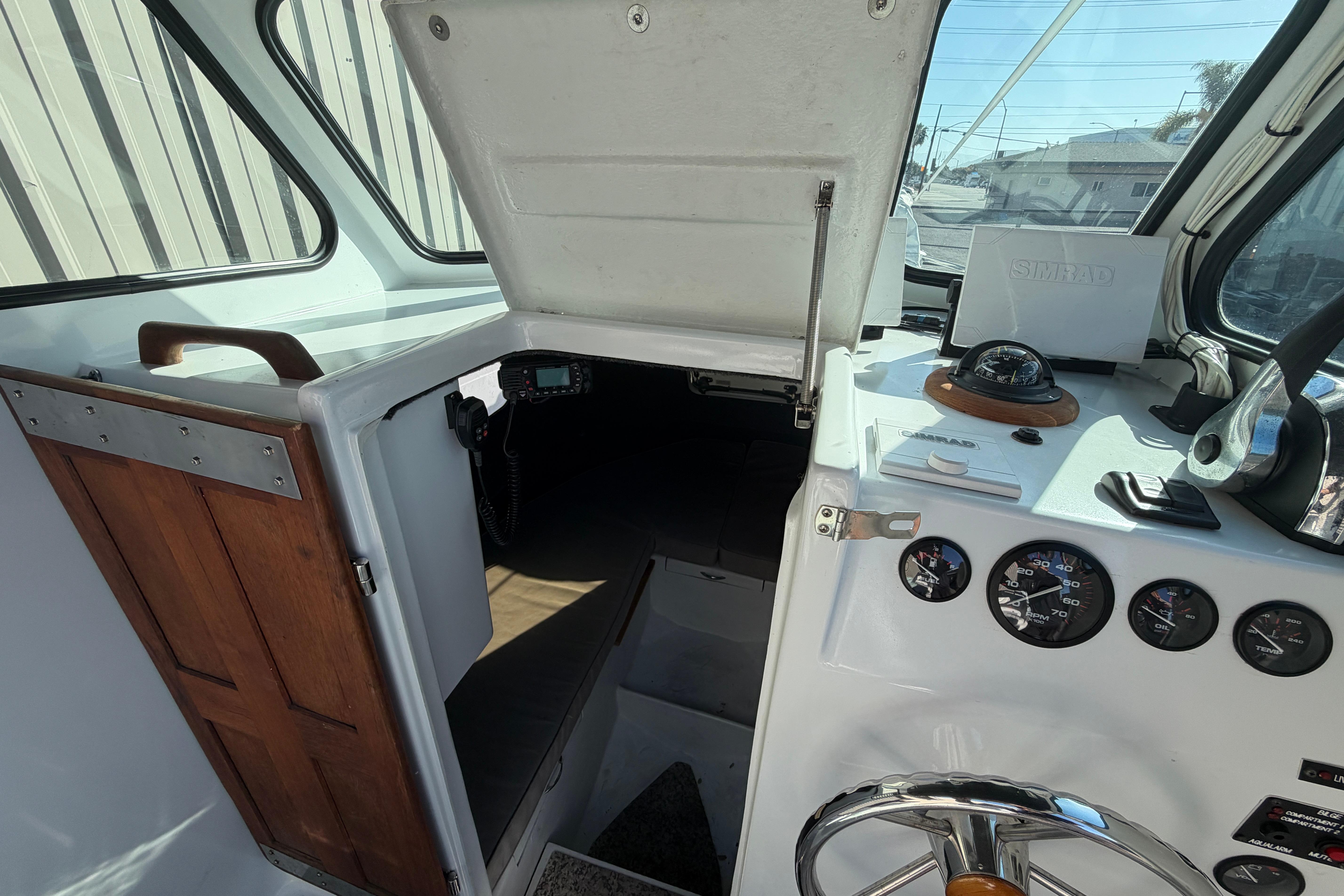 Interior view of a 1986 Radon 21 Sport boat cockpit with navigation instruments.