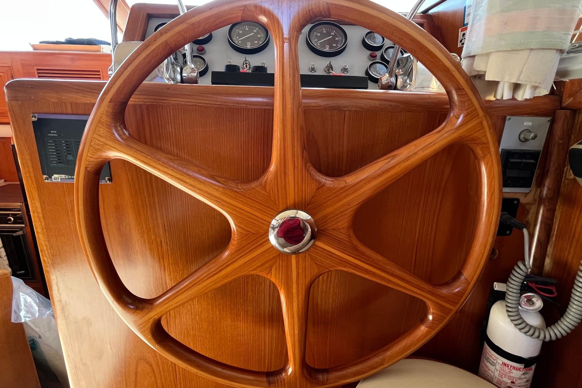 Wooden steering wheel of 1989 Ocean Alexander 440 Sundeck CPMY yacht cockpit.