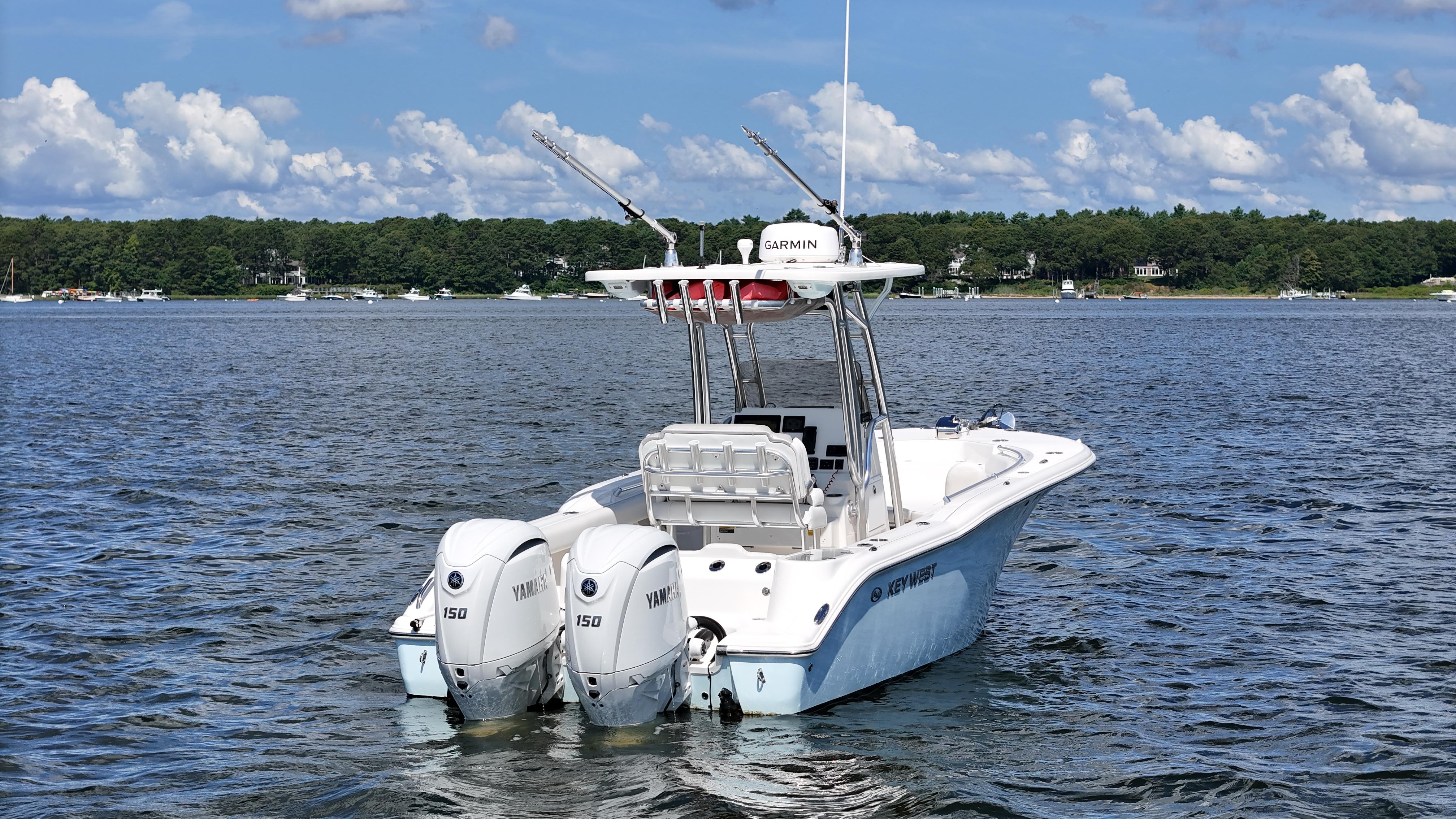 2024 Key West 244 Center Console boat with twin Yamaha engines on a lake.