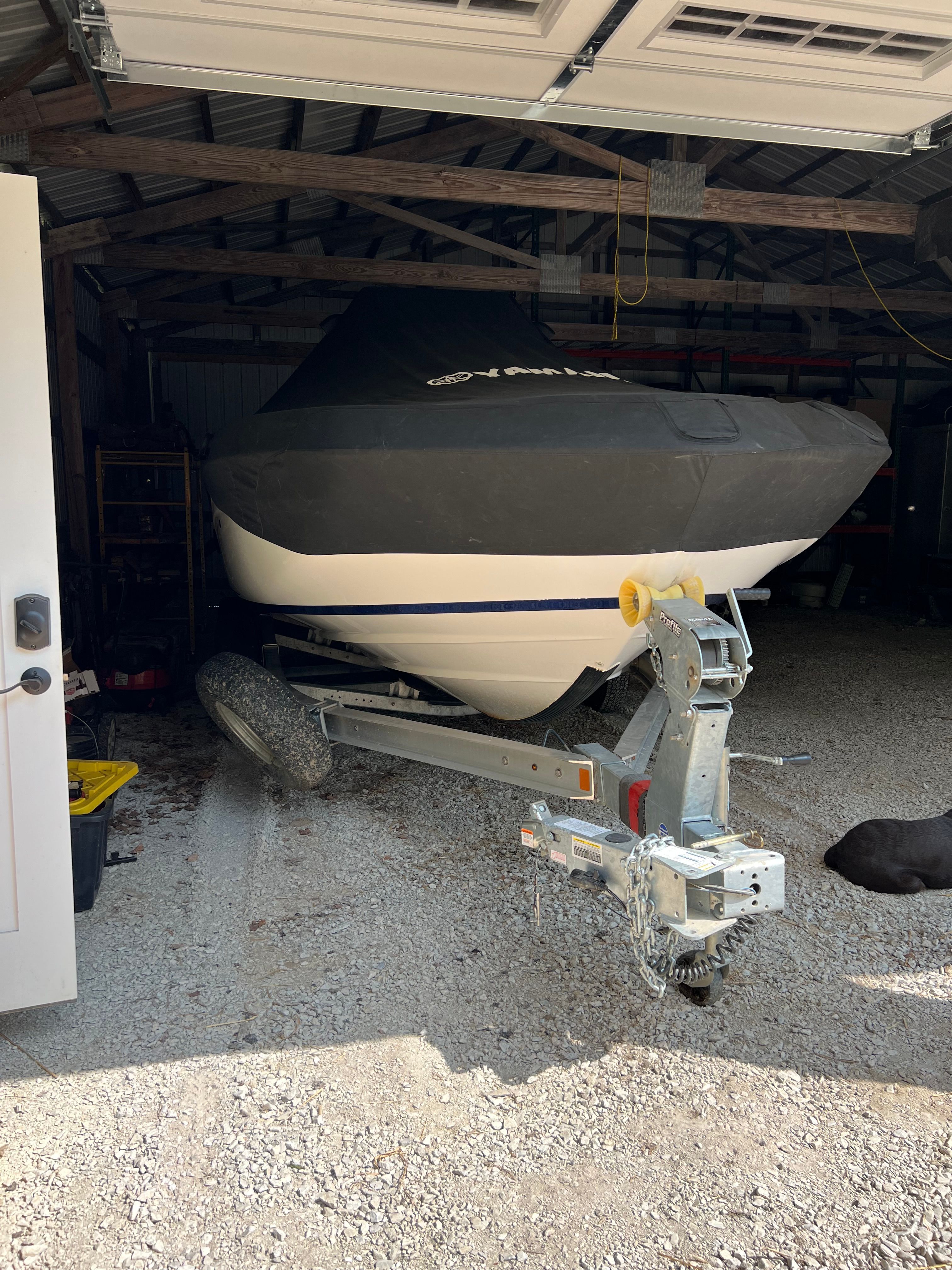 2022 Yamaha Boats 210 FSH Deluxe parked in a garage.