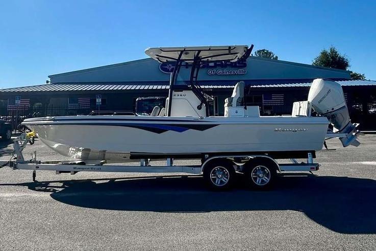 2026 Ranger 2360 Bay boat on trailer, parked outdoors, side view.