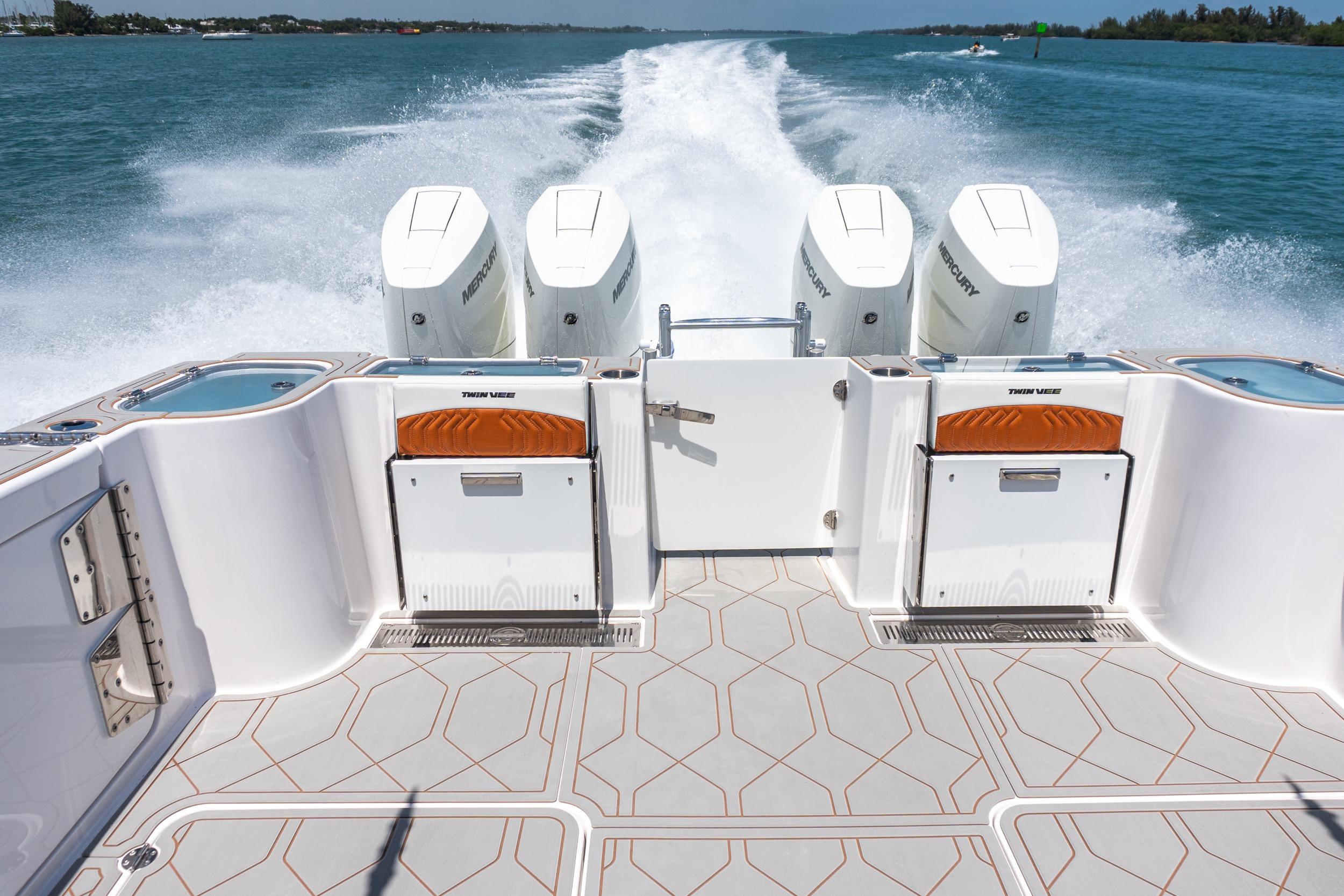 2026 Twin Vee 400 GFX2 CC boat with four powerful Mercury engines on open water.