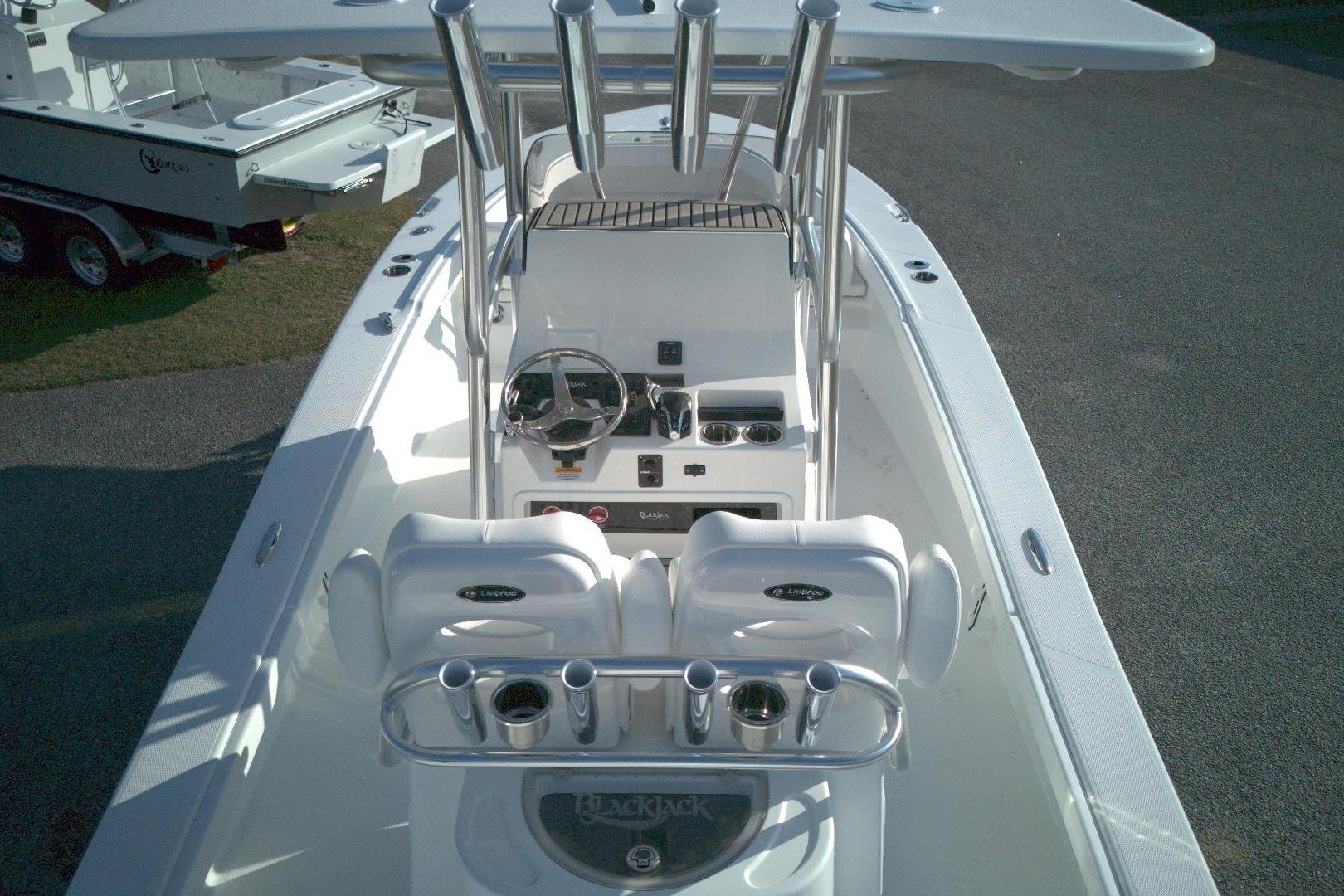 2026 BlackJack 256 Coastal boat interior with steering console and seating.