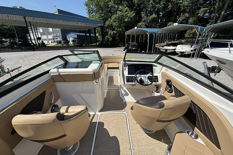 2019 Sea Ray SPX 230 Outboard boat interior with tan seating and modern dashboard.