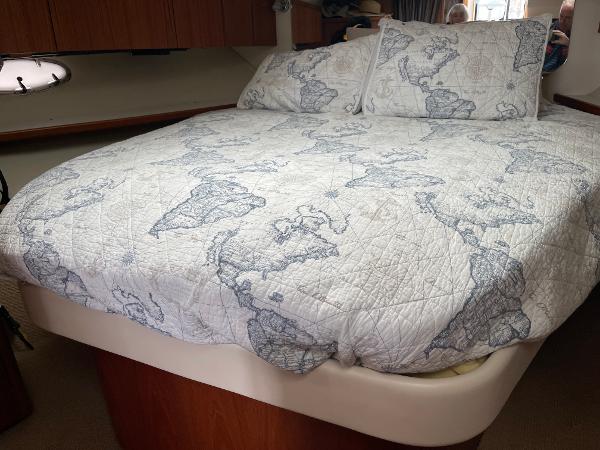 2003 Tiara Yachts 3500 Open cabin with map-themed bedding.