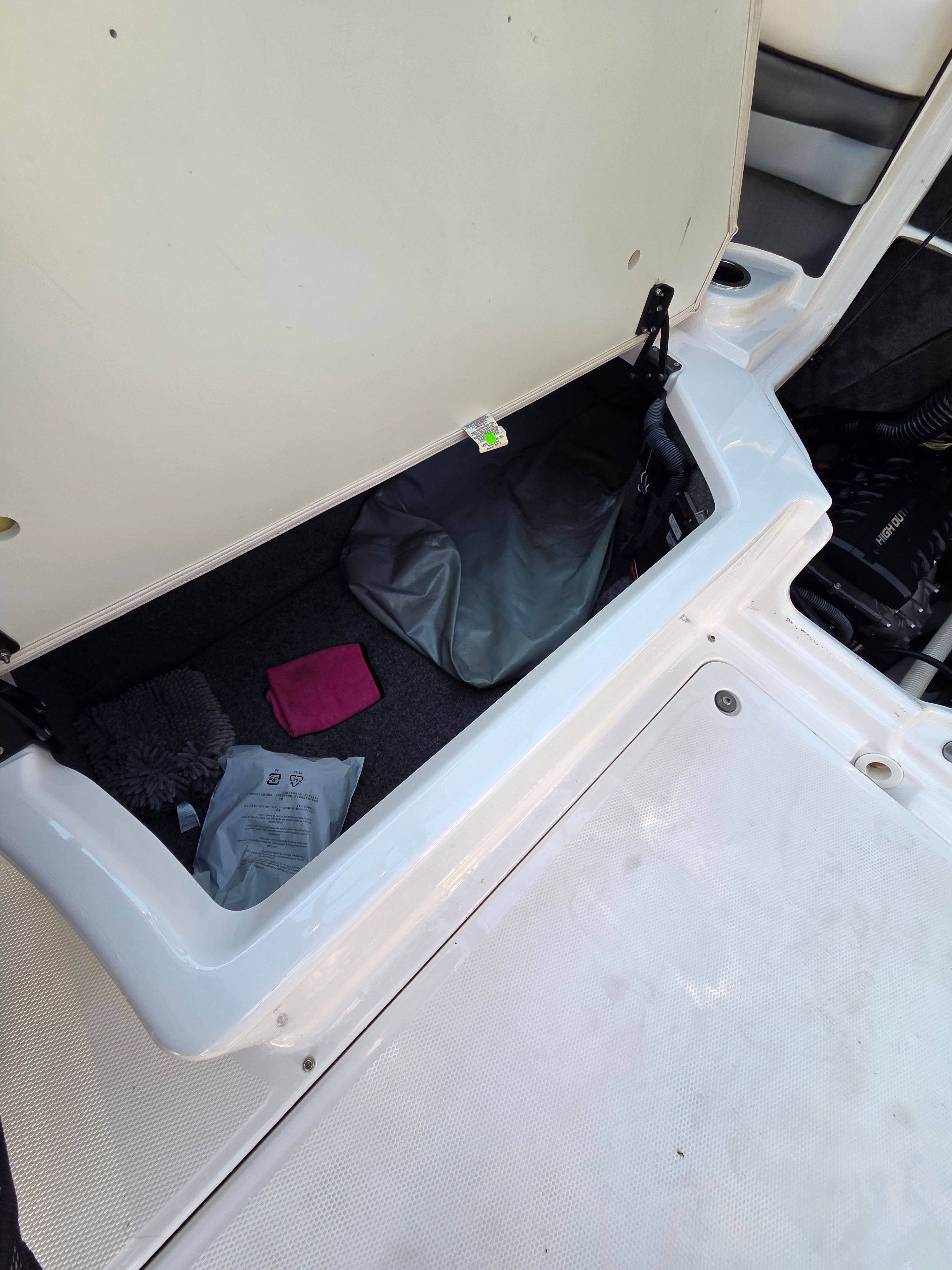 Boat storage compartment with various items inside.