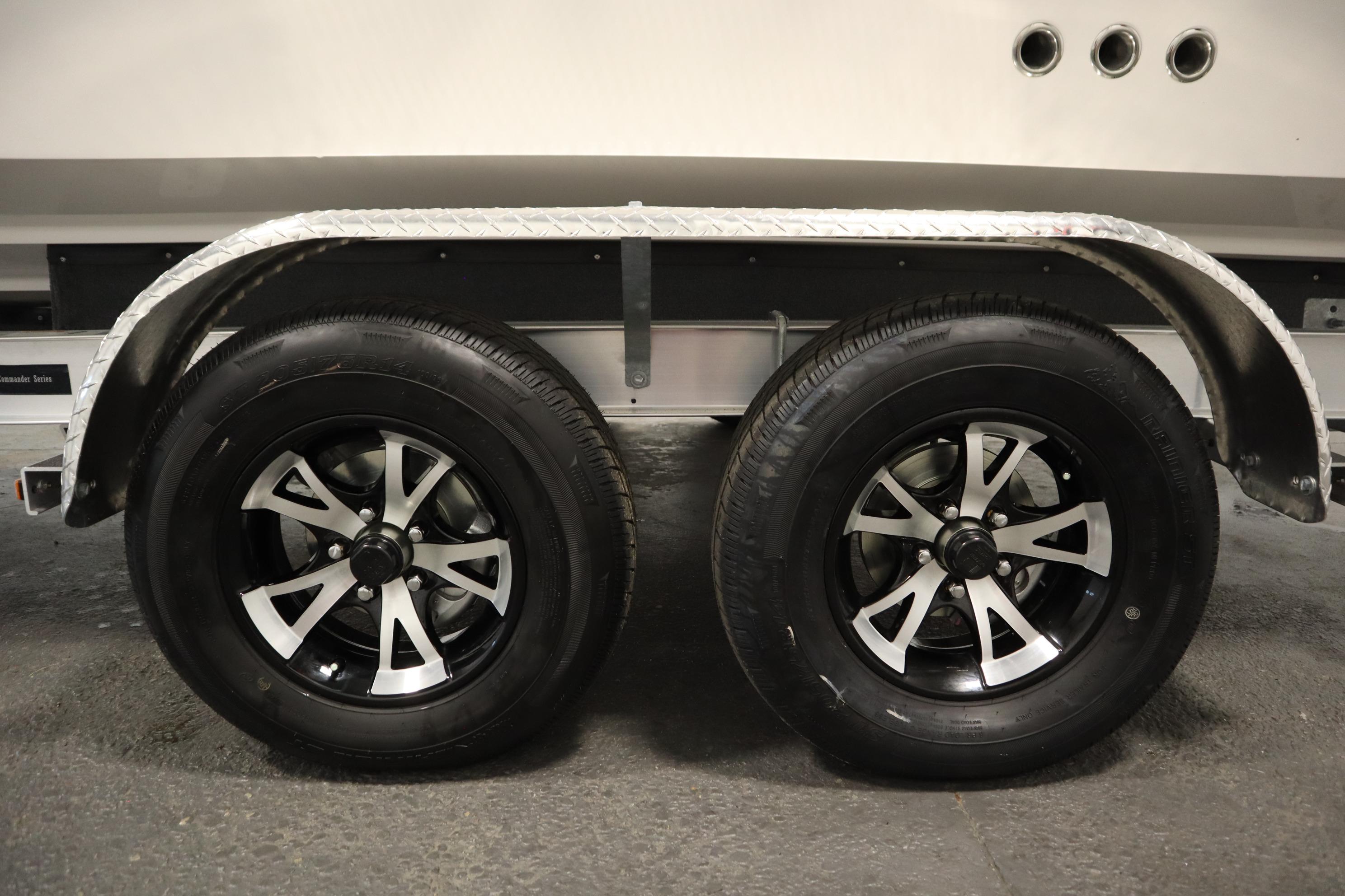 Trailer wheels of a 2026 Sea Fox 228 Commander boat, featuring sleek black and silver rims.