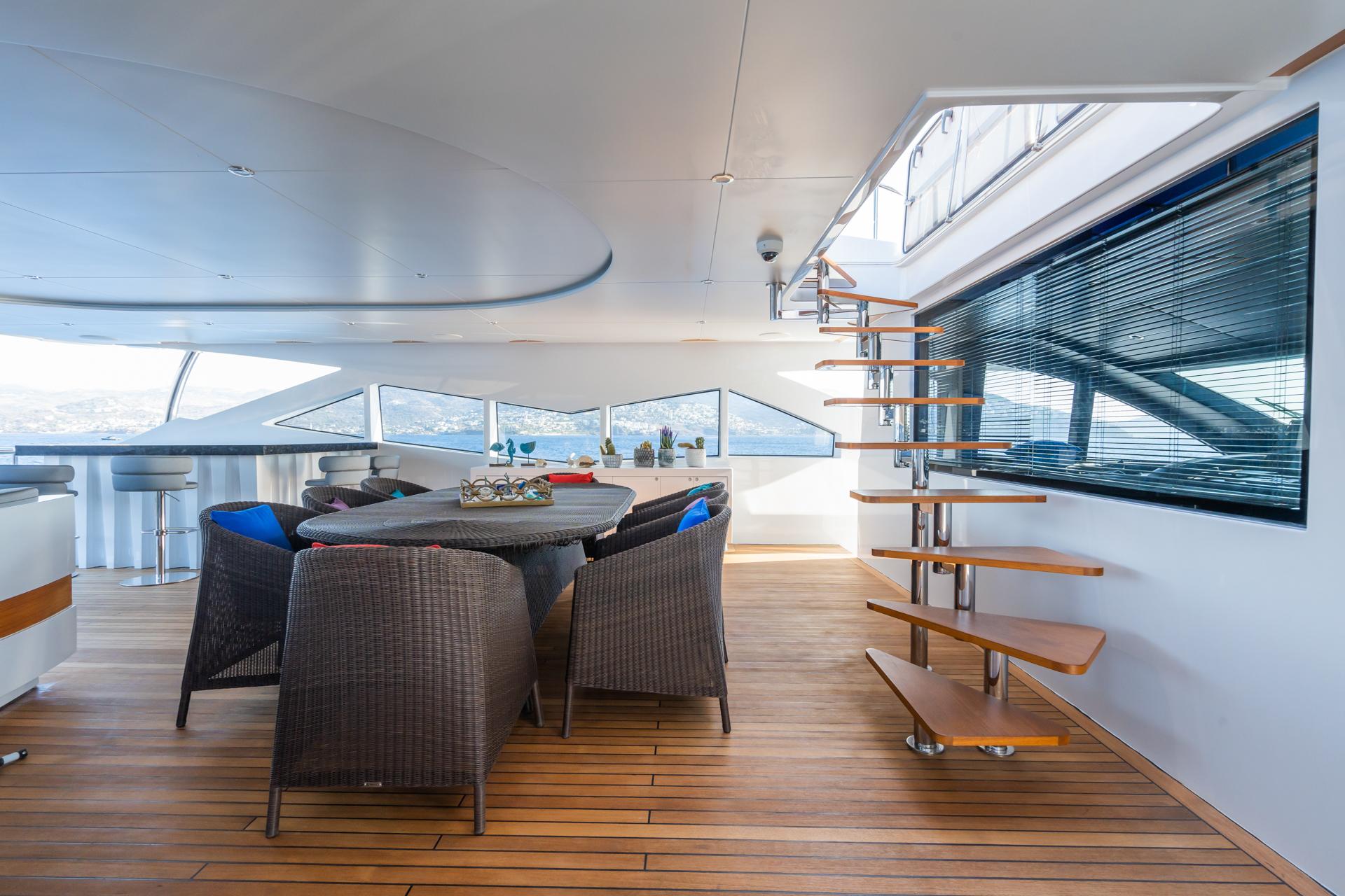 Luxurious 2018 Custom 37 Motoryacht interior with elegant dining area and modern staircase.
