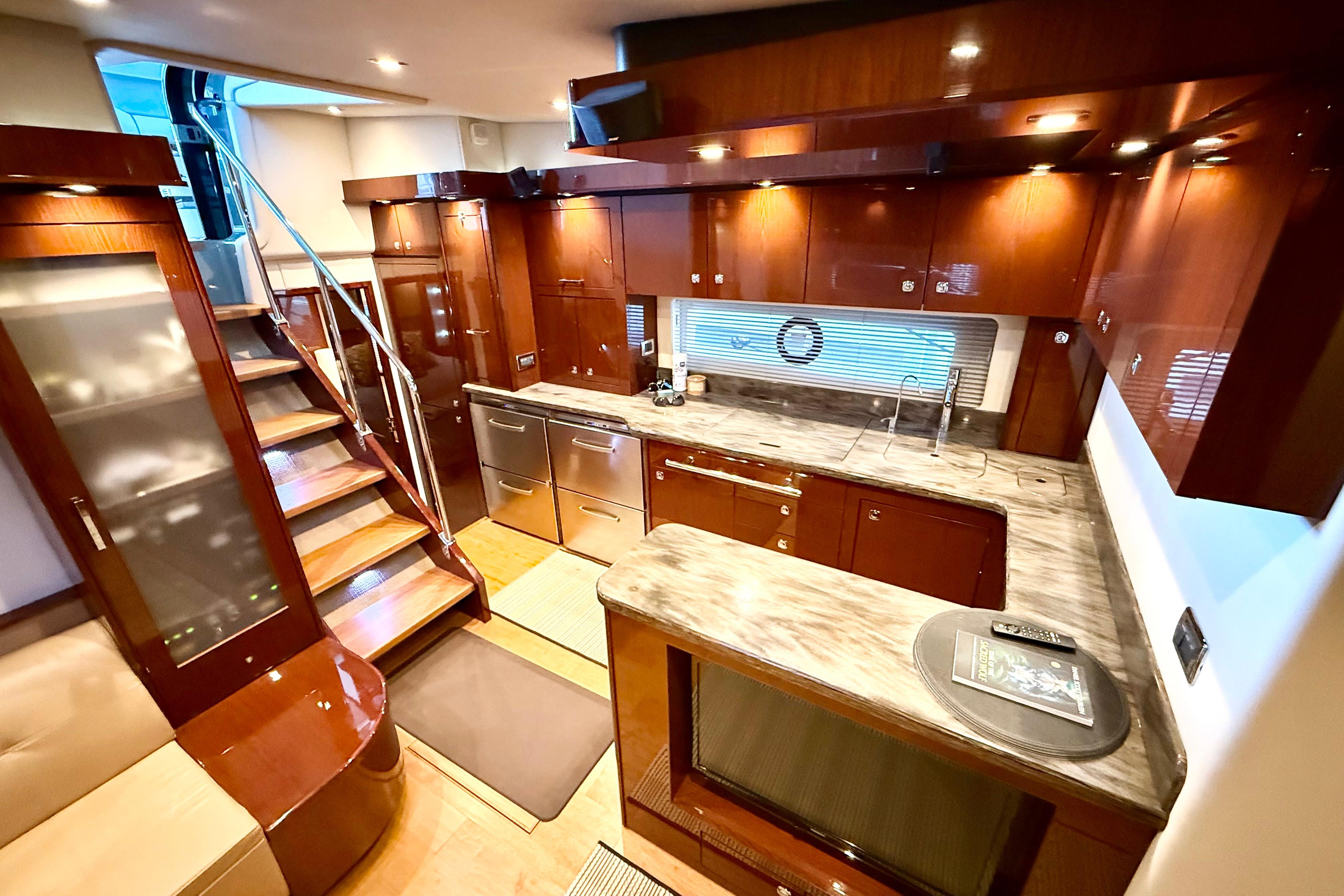 Luxurious 2014 Sea Ray 580 Sundancer yacht interior with modern kitchen and elegant wood finishes.