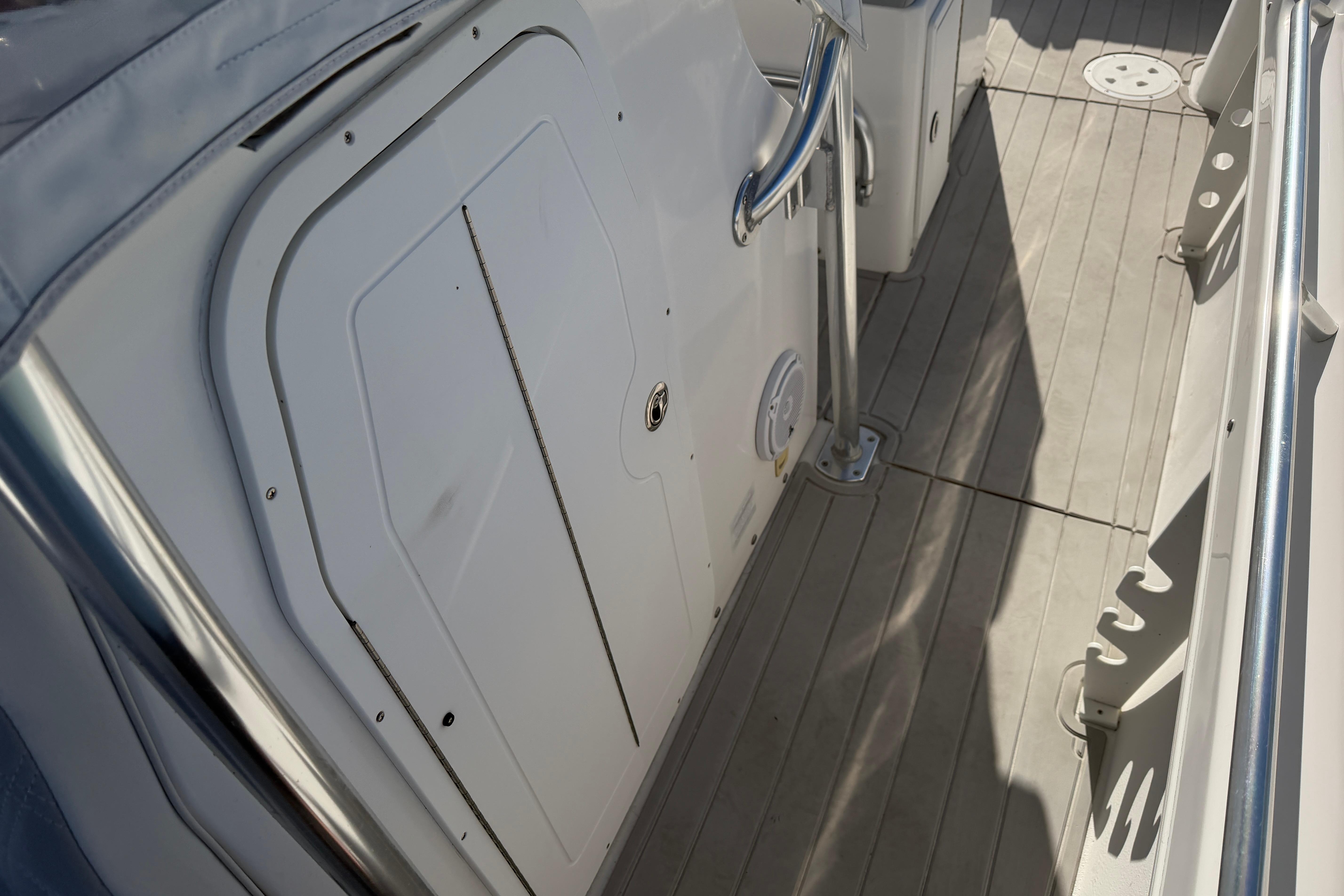 2018 Twin Vee 260 CC SE boat deck with storage compartment and railing.