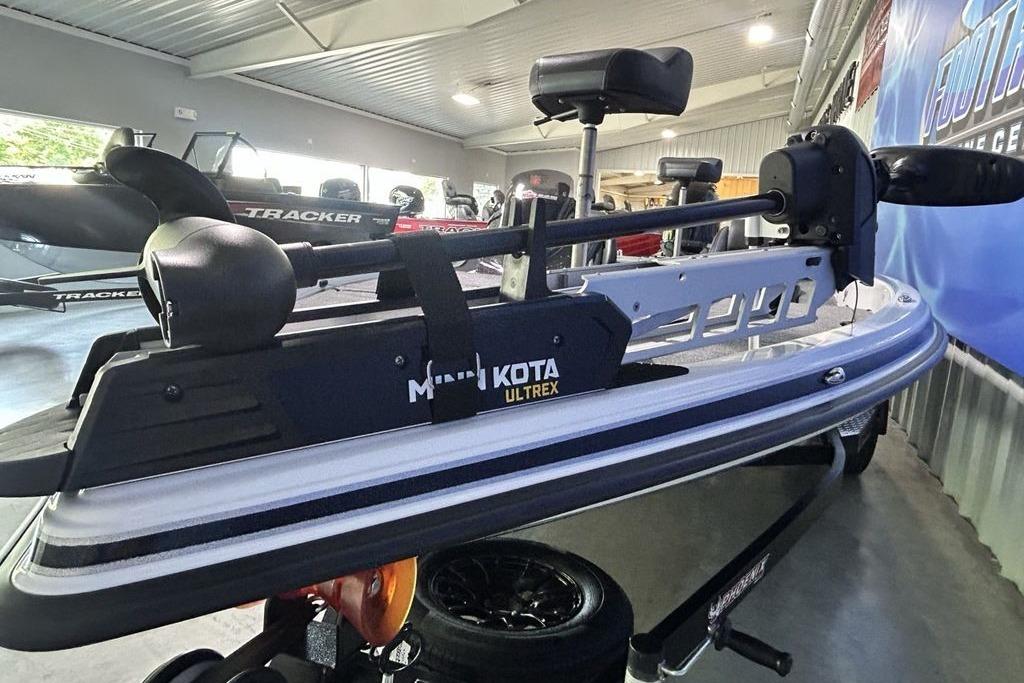 2026 Phoenix 818 Pro boat with Minn Kota Ultrex trolling motor in showroom.