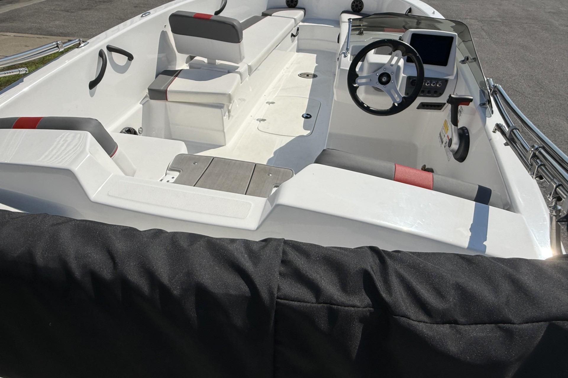 2024 Tahoe T18 boat interior with steering wheel, seating, and dashboard.