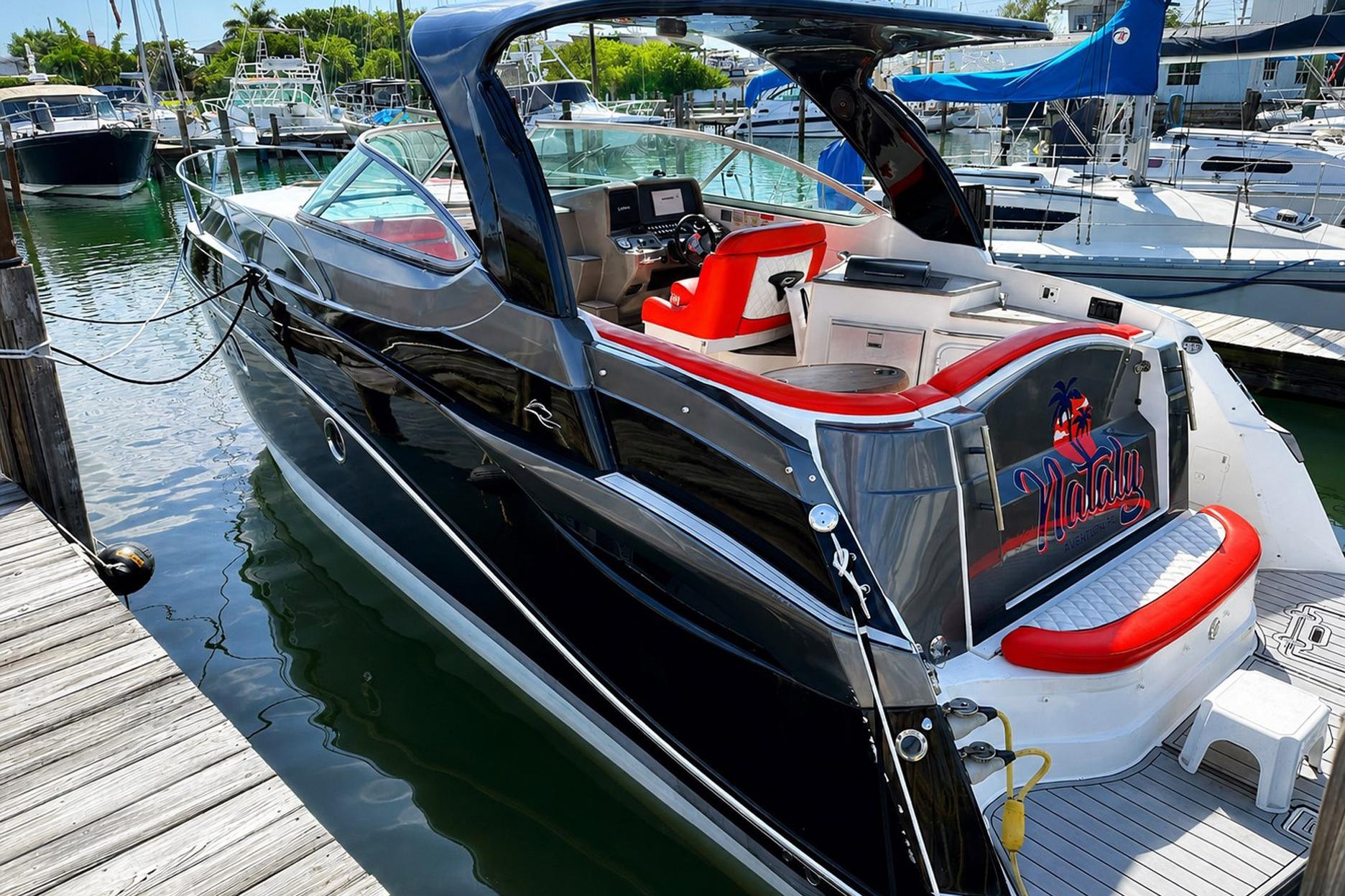 2012 Rinker 310 Express Cruiser LE docked at marina, featuring sleek design and vibrant interior.