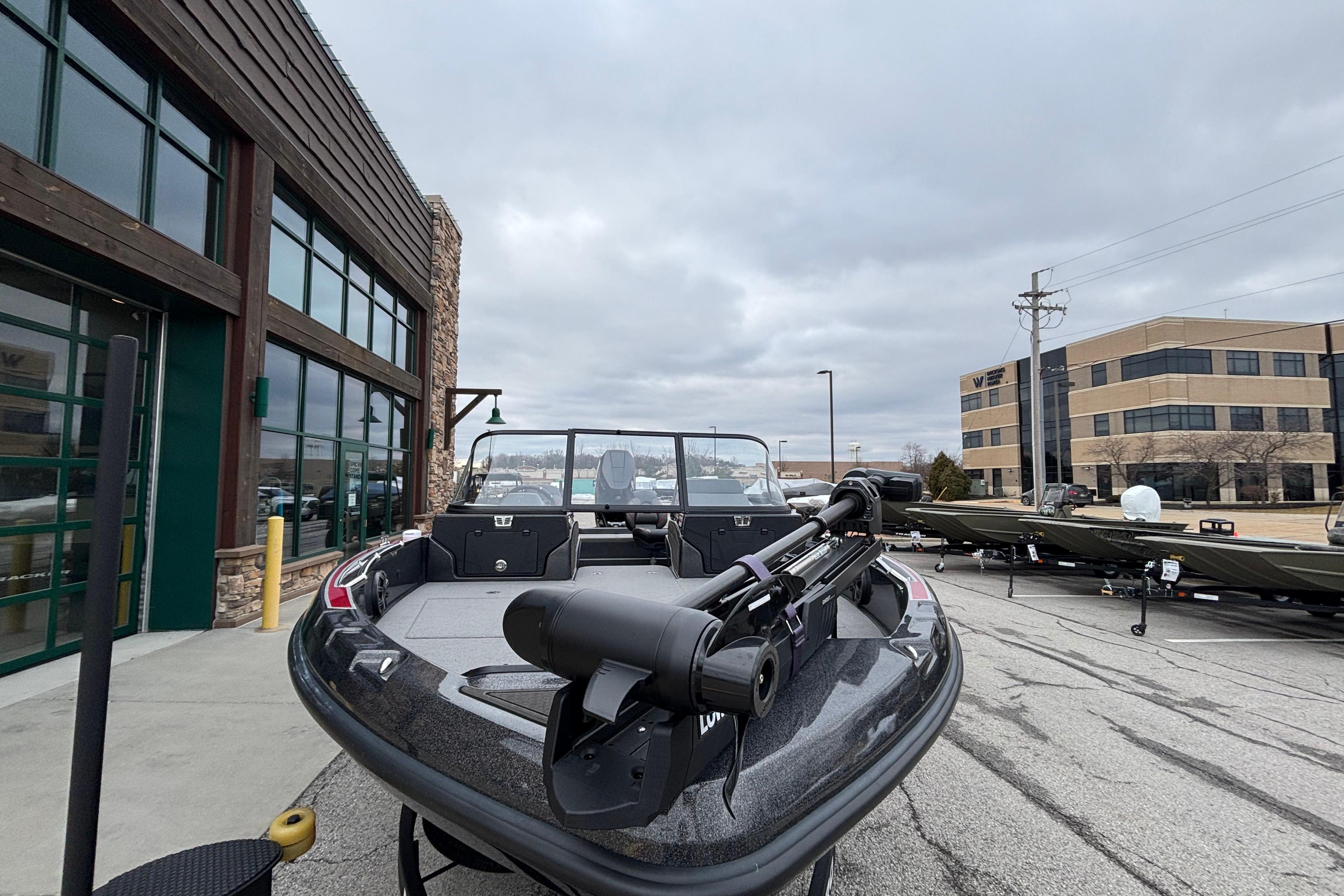 2024 Nitro ZV21 Pro boat displayed outdoors near commercial buildings.