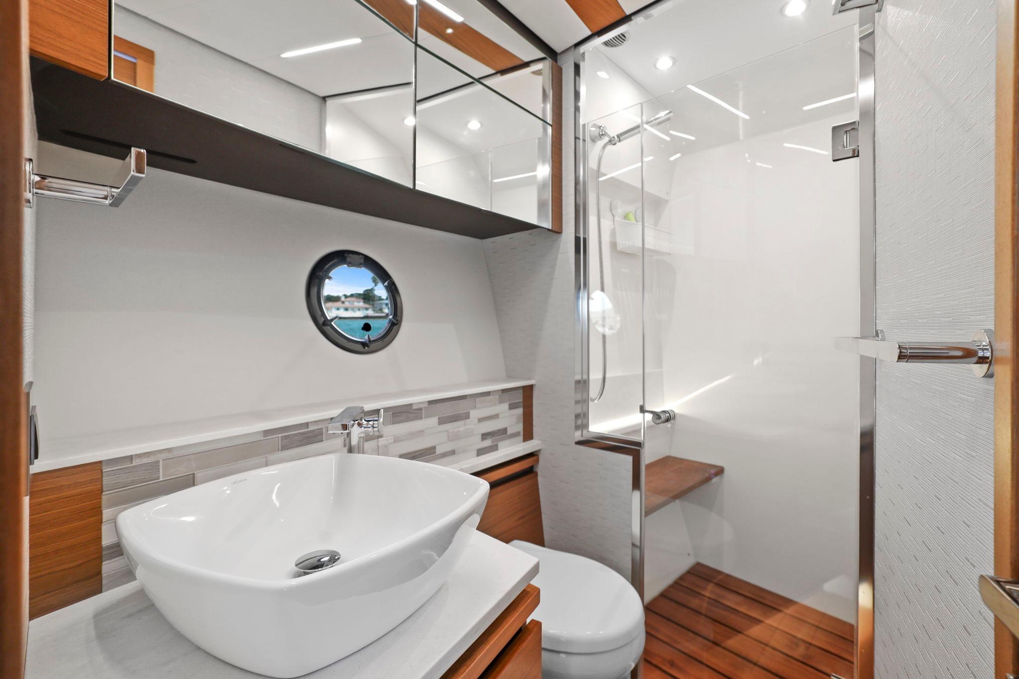 Luxurious bathroom in 2023 Tiara Yachts C49 Coupe with modern fixtures and elegant design.