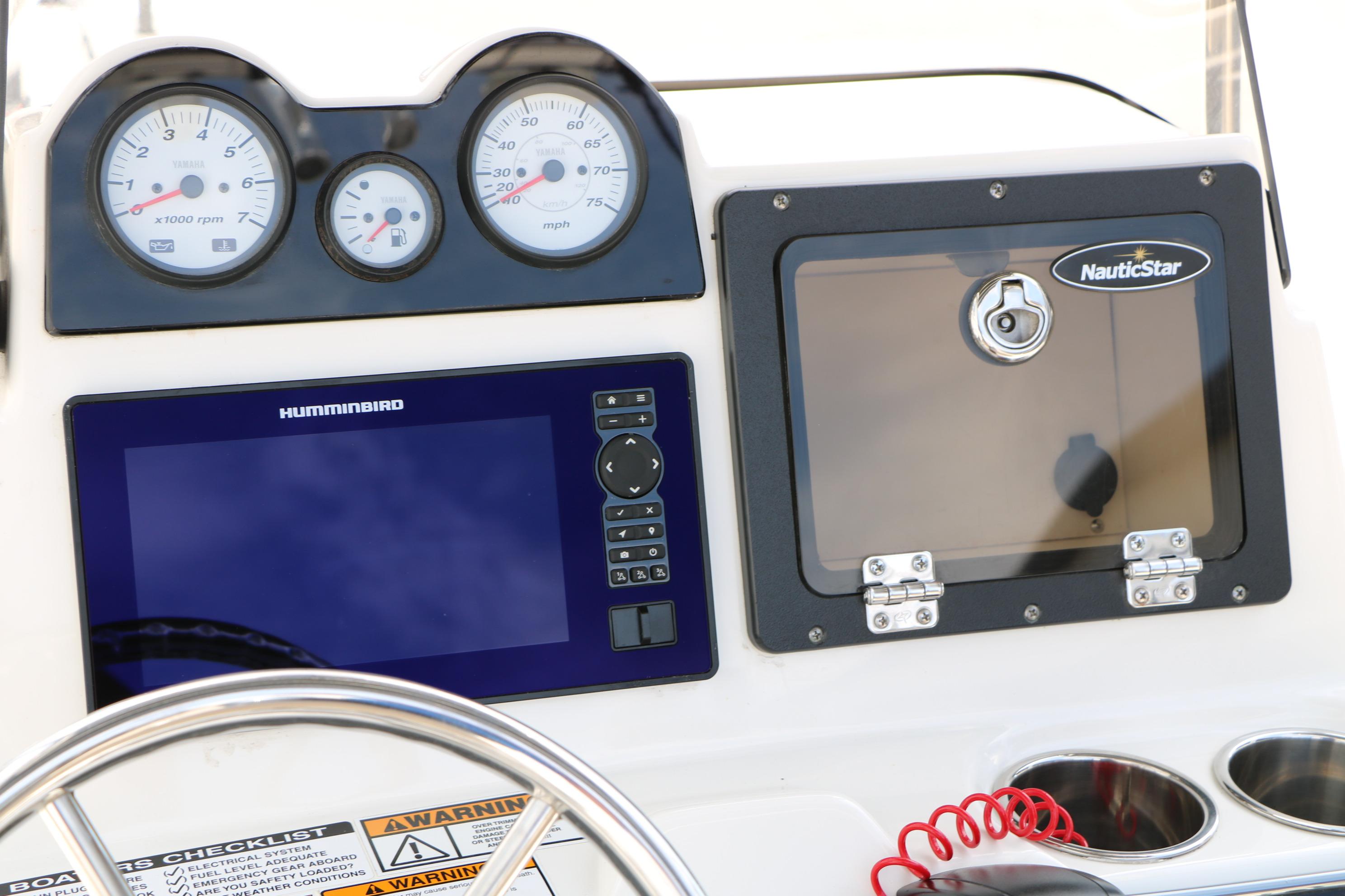 Dashboard of 2020 NauticStar 2140 Sport boat with gauges and Humminbird display.