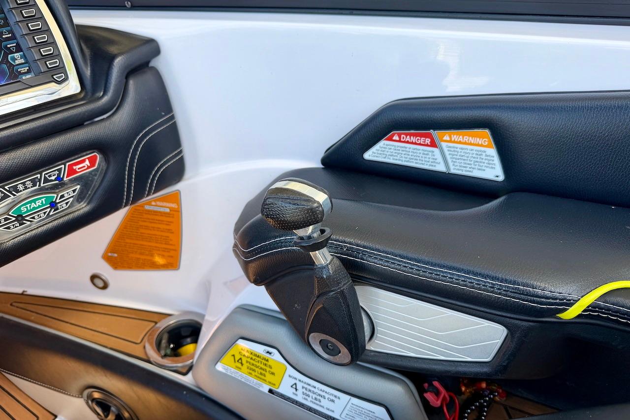 2014 Nautique Super Air Nautique G21 dashboard with controls and warning labels.