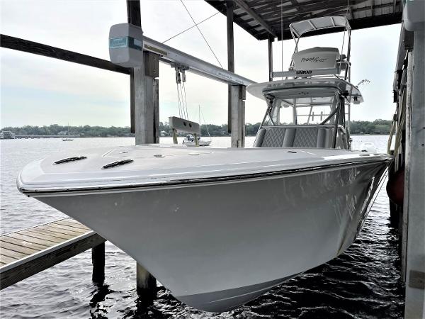 2020 Front Runner 39 Center Console boat docked under a covered marina.