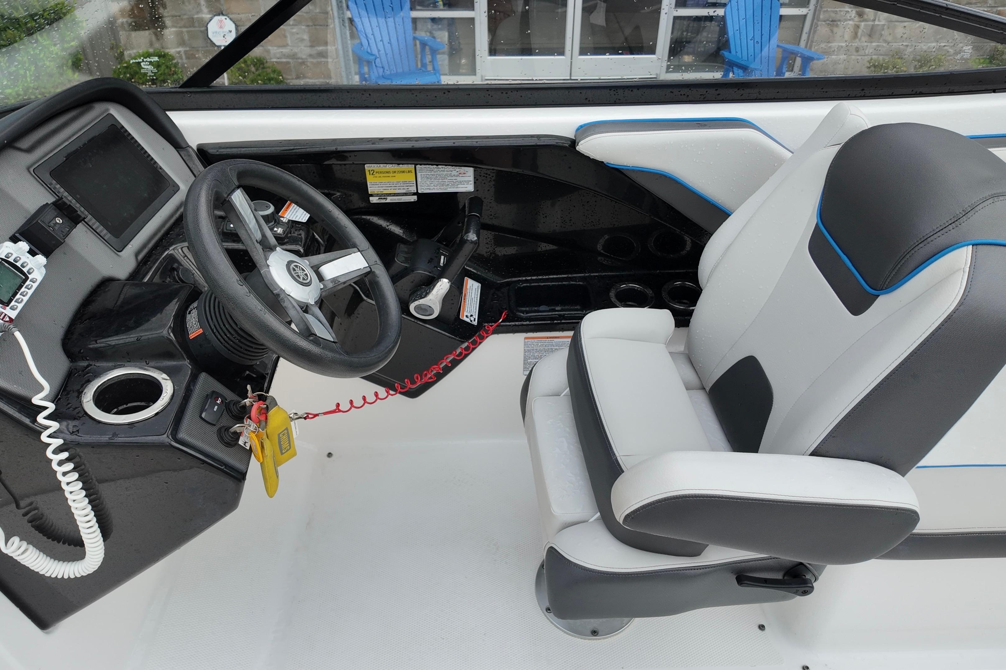 2020 Yamaha Boats AR240 cockpit with steering wheel and captain's chair.