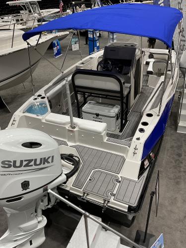 2025 Starcraft SVX 211 OB CC boat with blue canopy and Suzuki outboard motor.