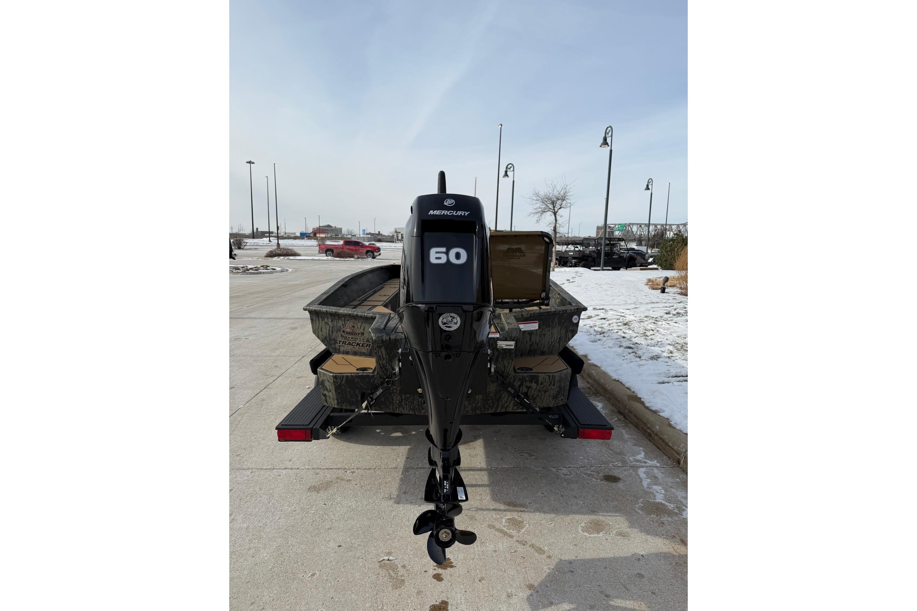2026 Tracker Grizzly 1756 T Marsh boat with Mercury 60 engine on snowy pavement.
