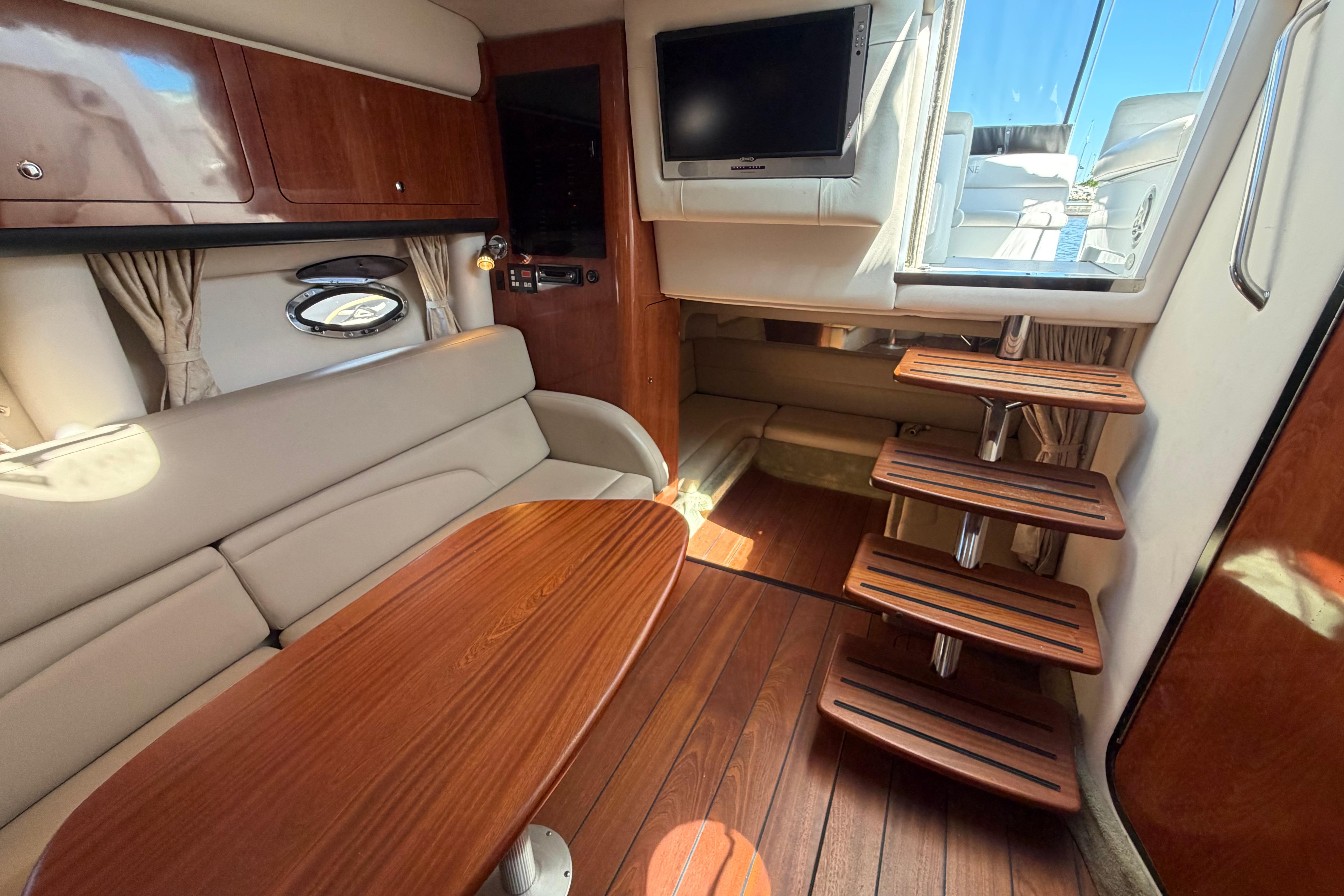 Interior of 2008 Crownline 340 CR yacht with wooden flooring and seating area.
