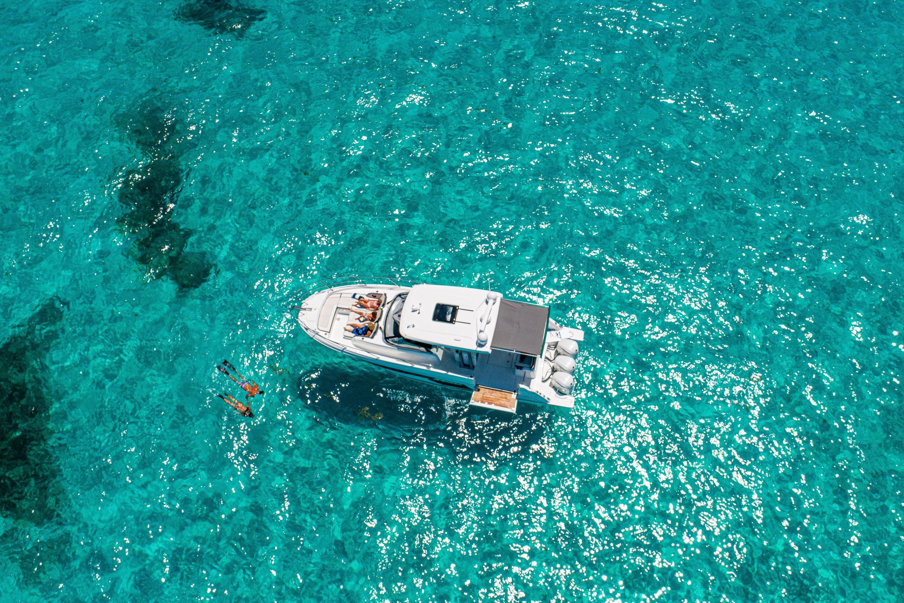 Aerial view of 2026 Jeanneau Leader 12.5 WA yacht on clear turquoise water.