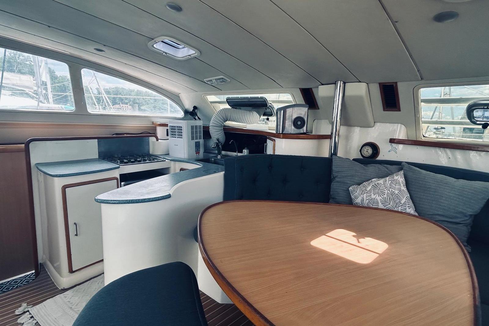 Interior of a 2001 Robertson & Caine Leopard yacht with kitchen and seating area.