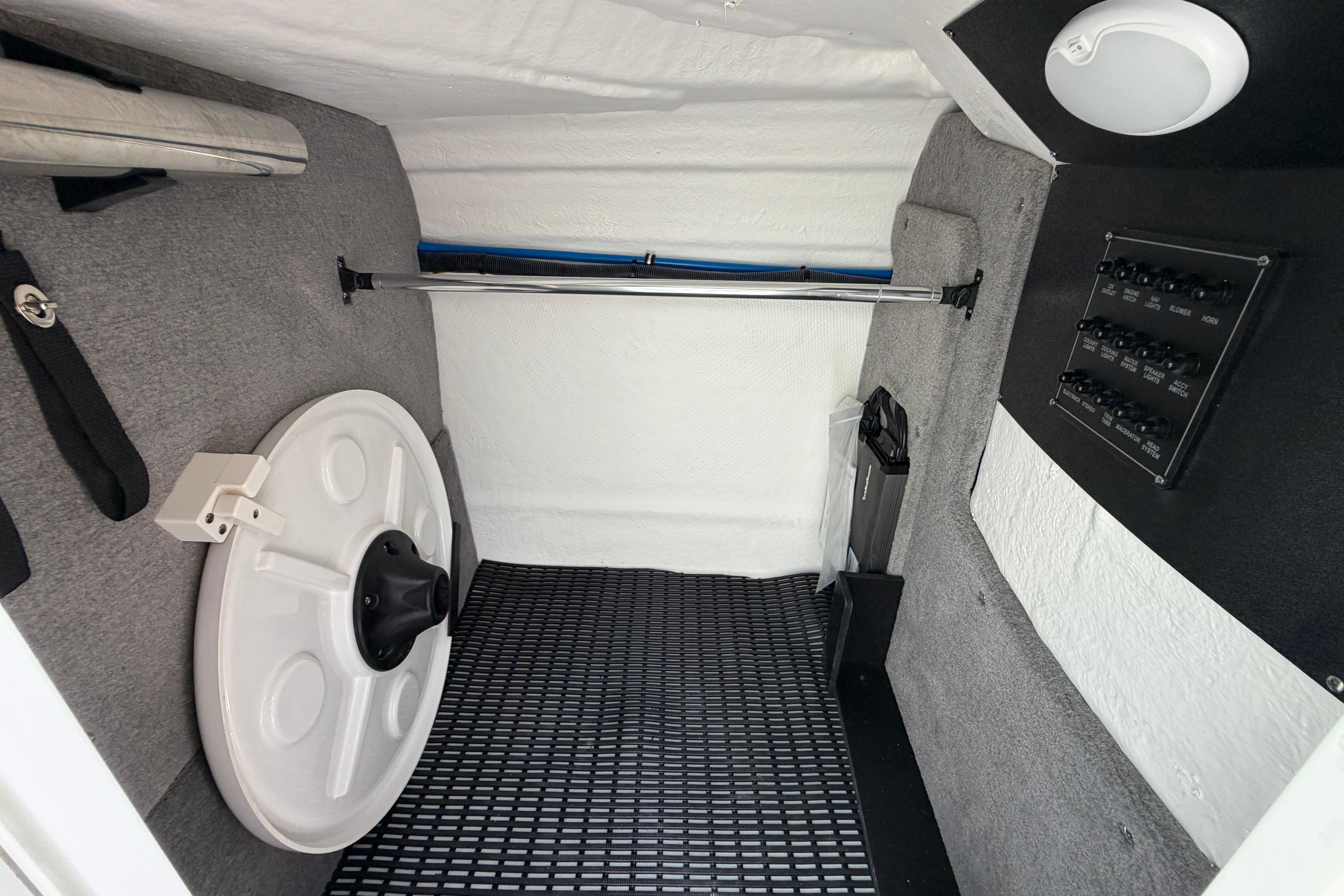 Interior of 2025 Monterey M6 boat storage compartment with equipment and control panel.