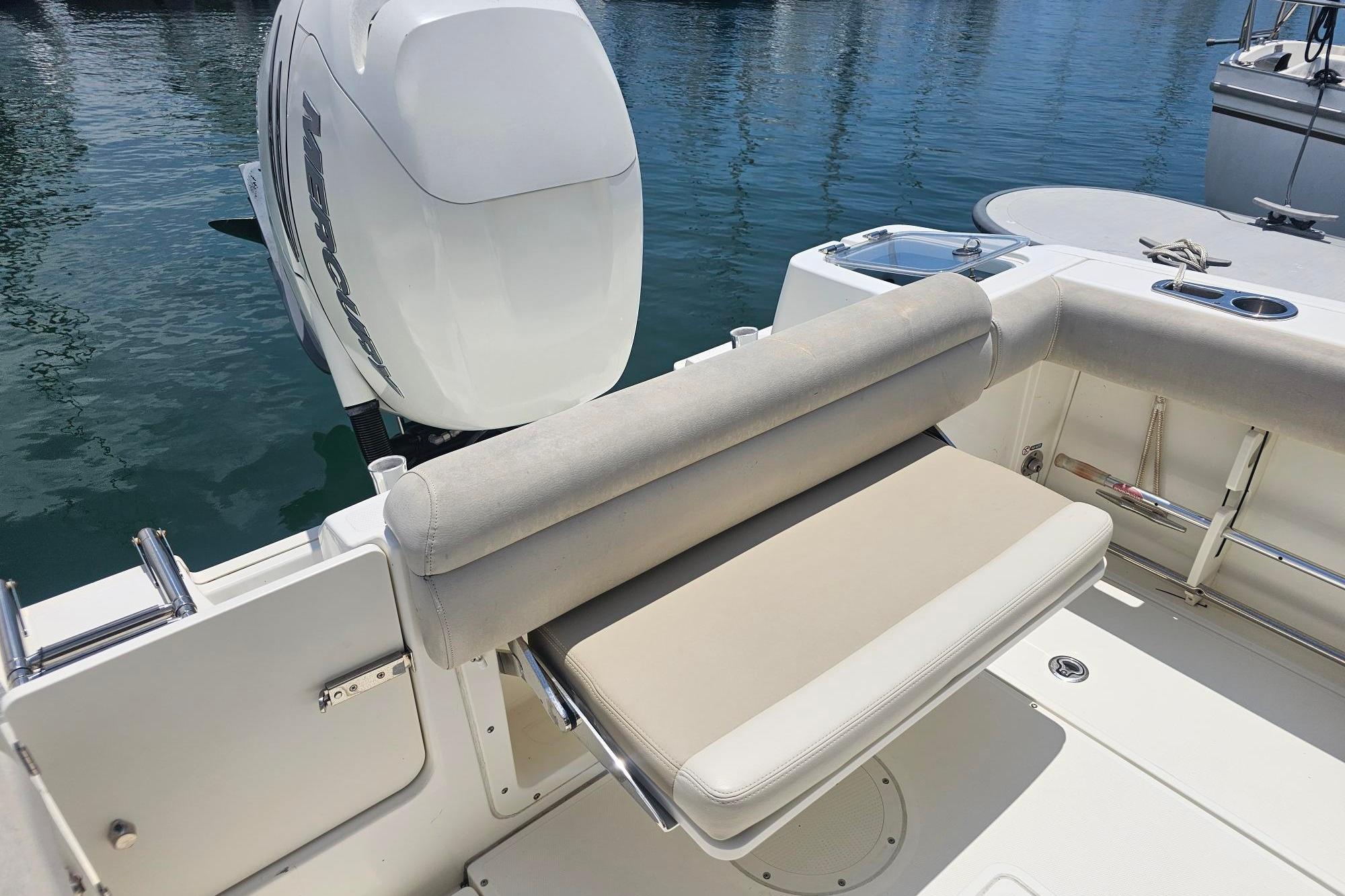 2017 Boston Whaler 230 Outrage boat with cushioned seating and Mercury outboard motor.