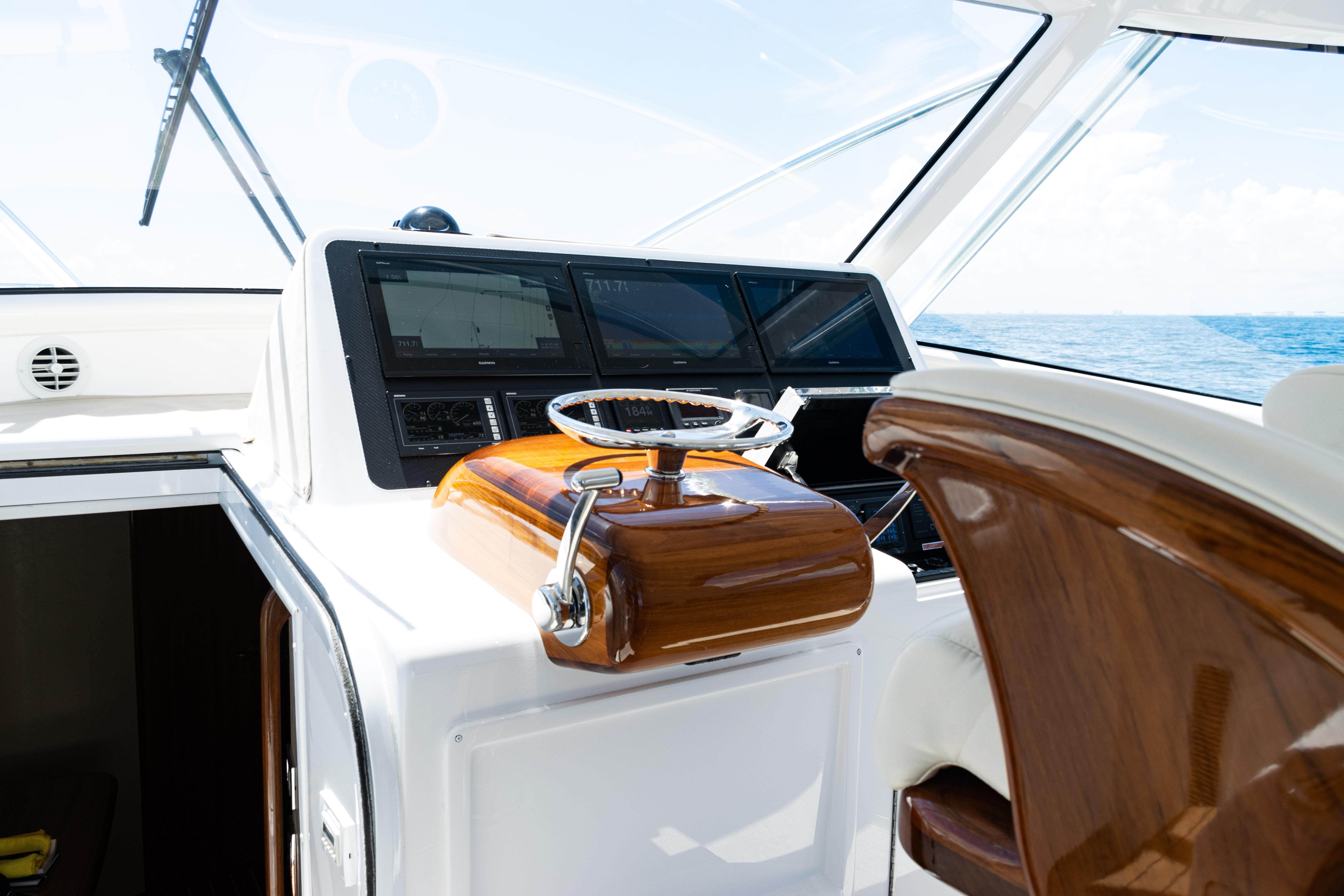 2021 Viking 44 Open yacht helm with polished wood and modern navigation displays.