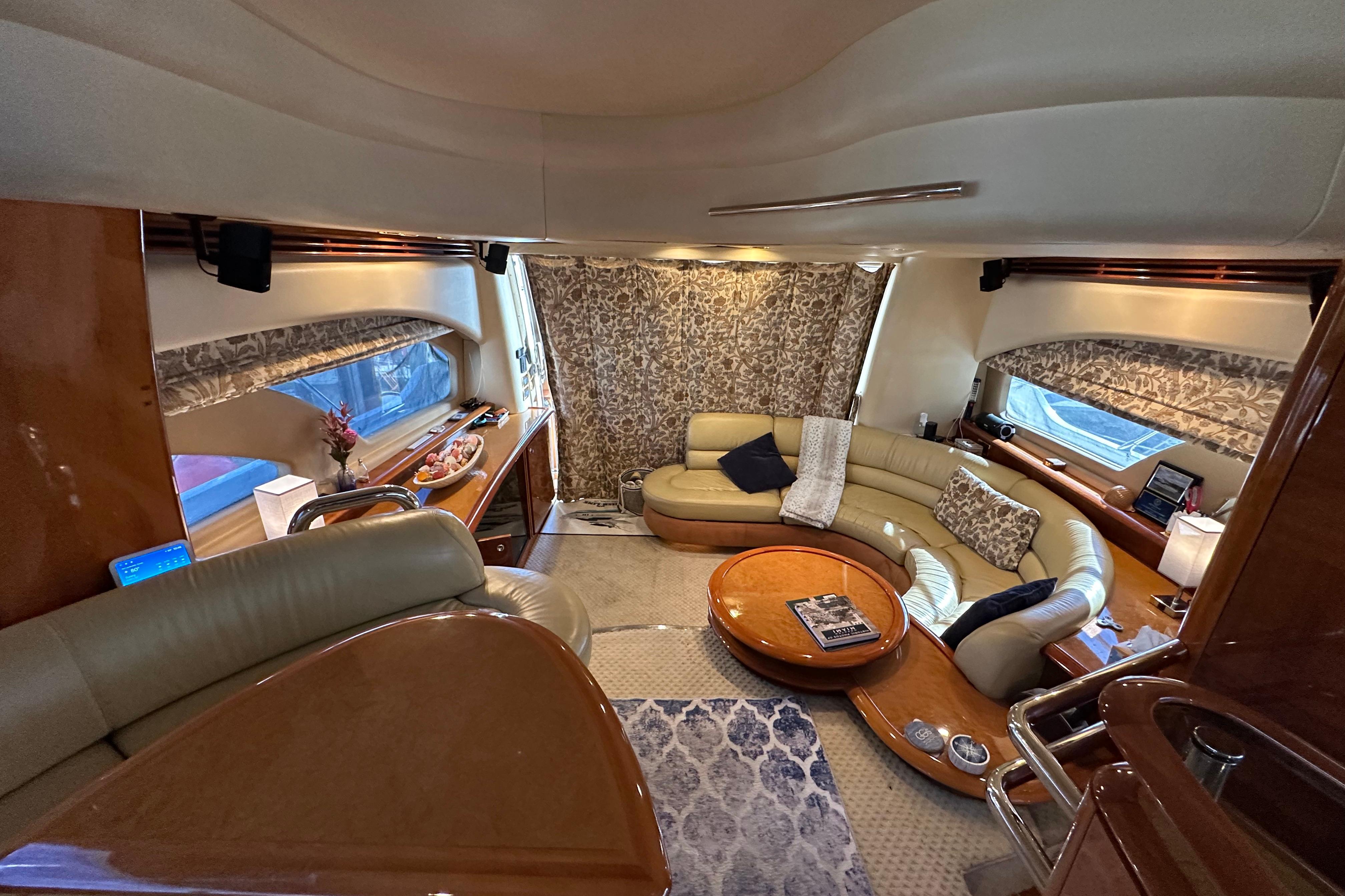 Luxurious interior of a 2004 Azimut 55E yacht with elegant seating and decor.