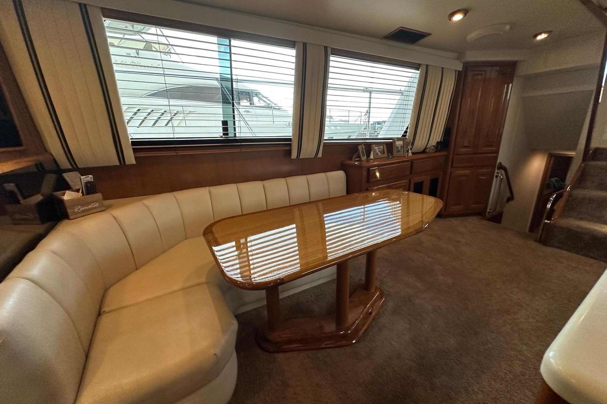 Interior of 1998 Viking 54 Motor Yacht with elegant seating and wooden table.