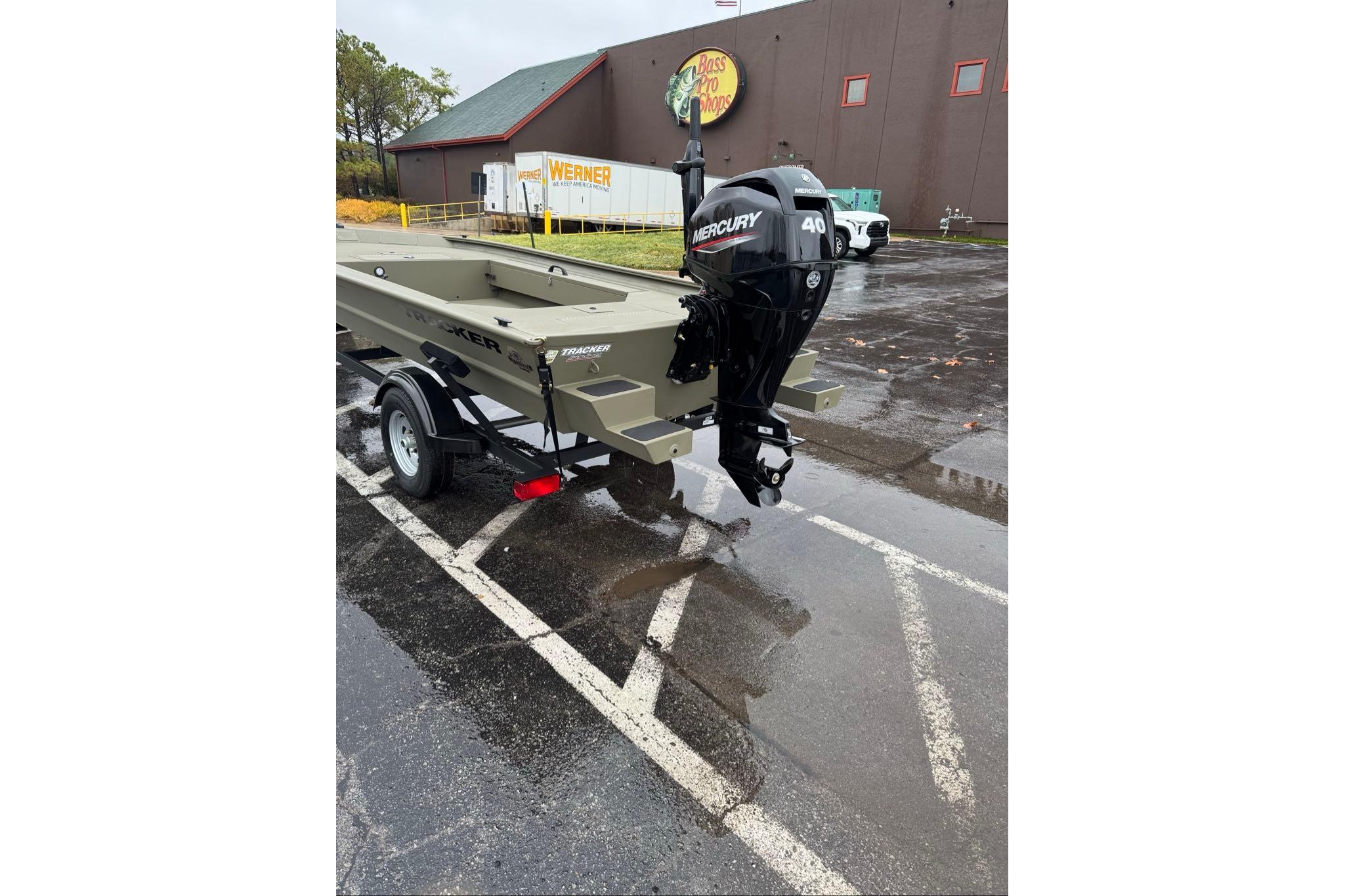 2026 Tracker Grizzly 1654 T Sportsman boat with Mercury 40 engine in parking lot.