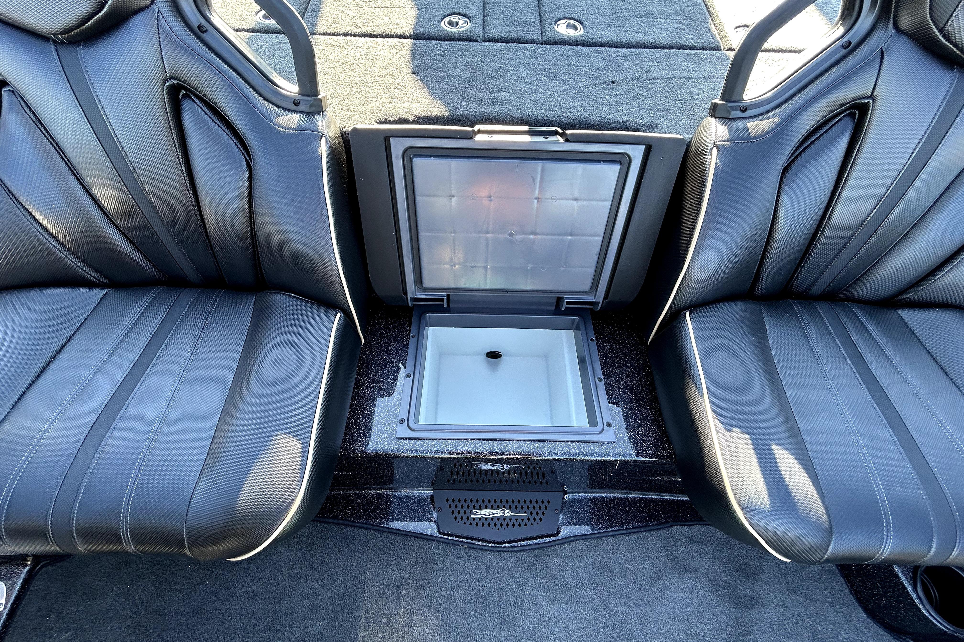 2026 Skeeter ZXE21 boat interior with open storage compartment between two seats.