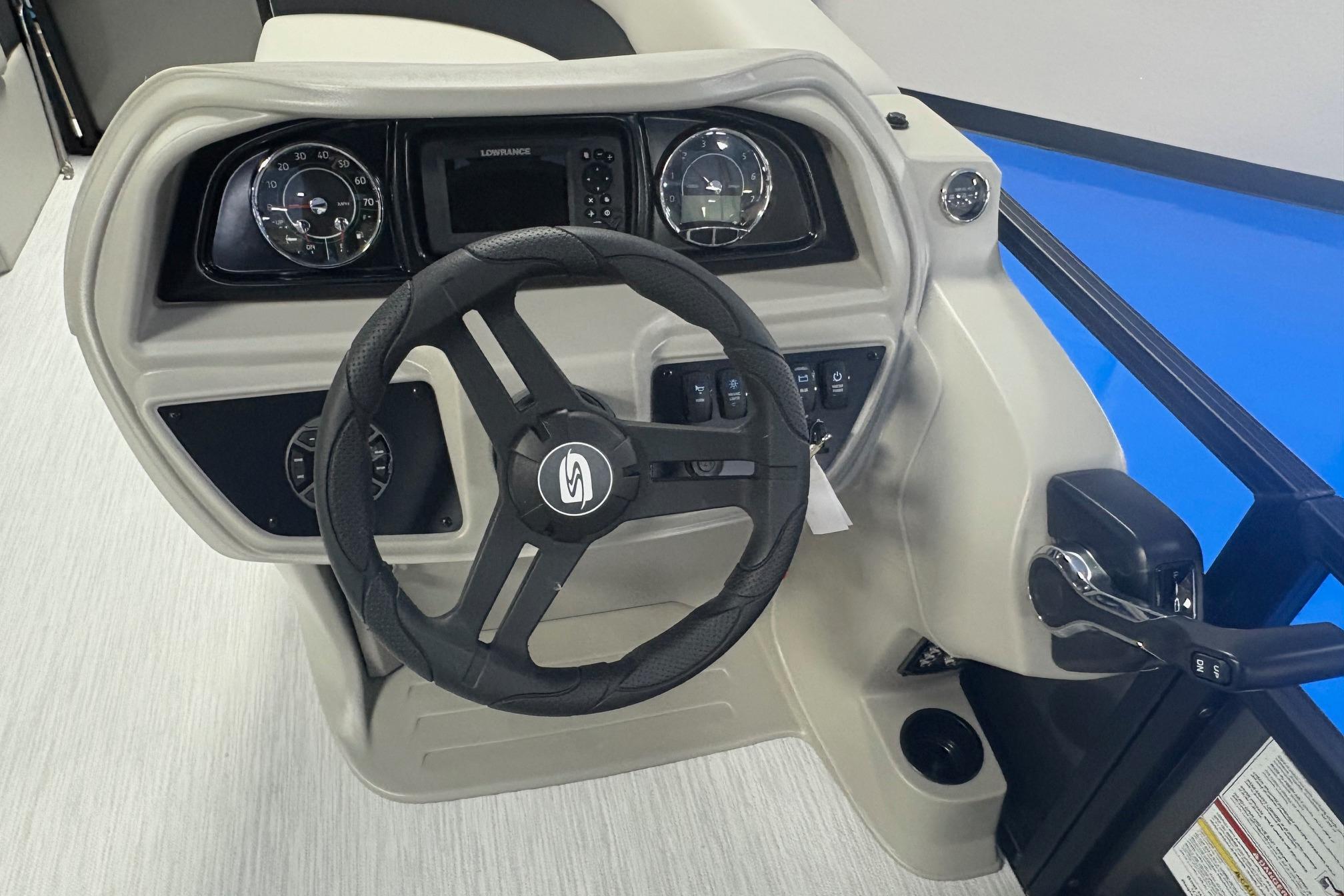 2026 Dockside 22DQ boat dashboard with steering wheel and control panel.