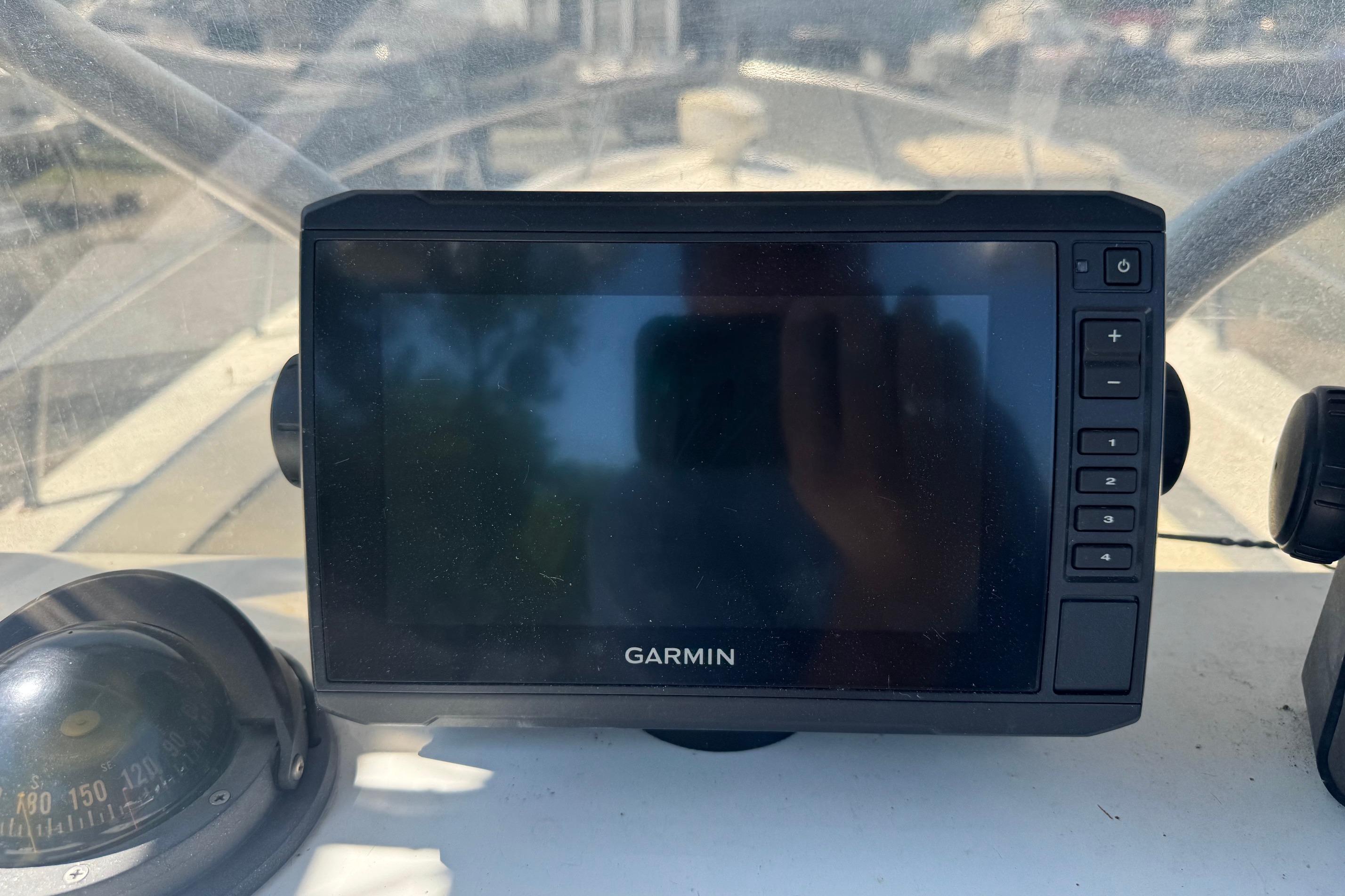 Garmin navigation system on a 1997 Maycraft 23 boat dashboard.