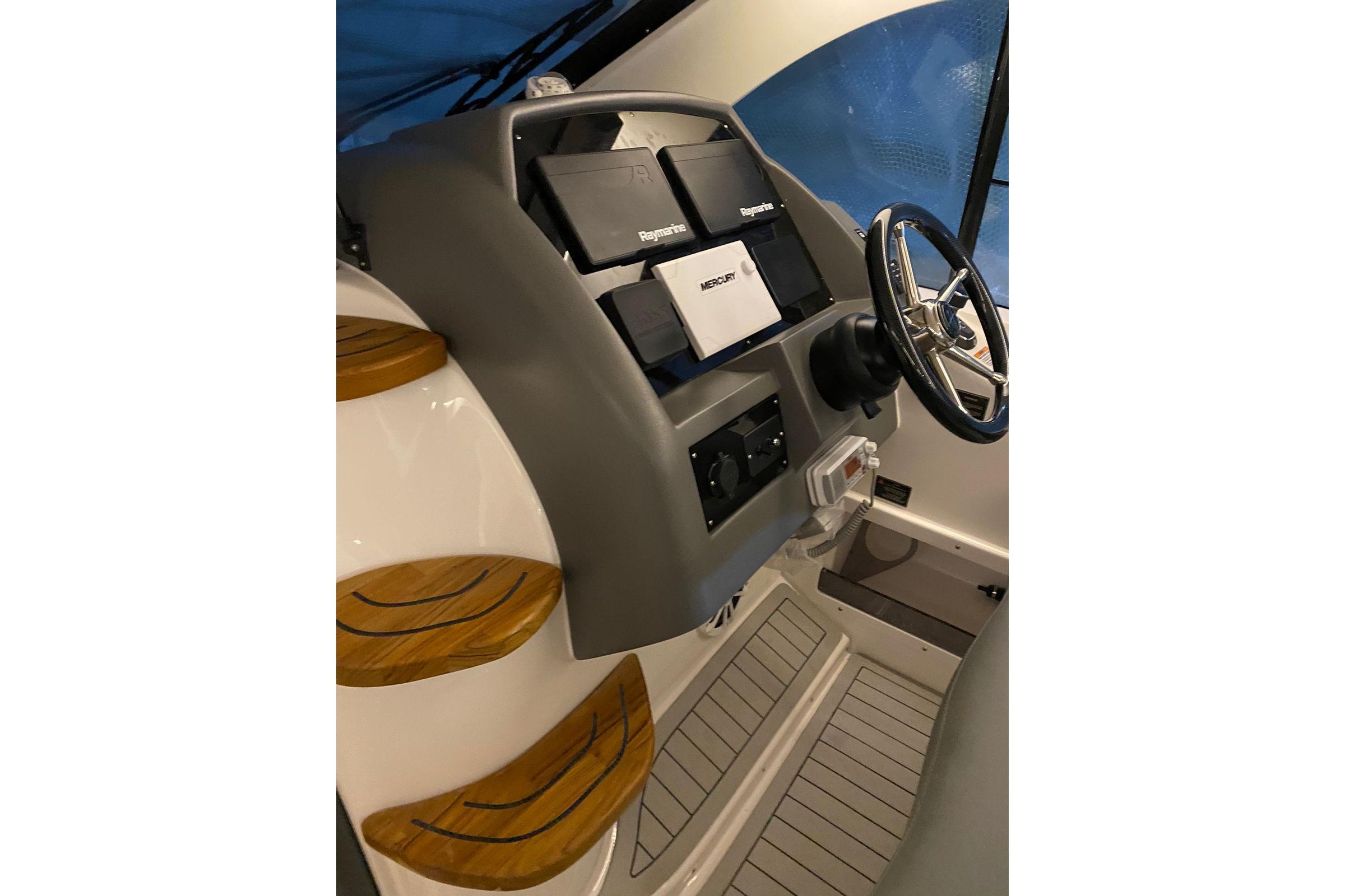 Interior of 2026 Hanover 375 boat with modern dashboard and steering wheel.