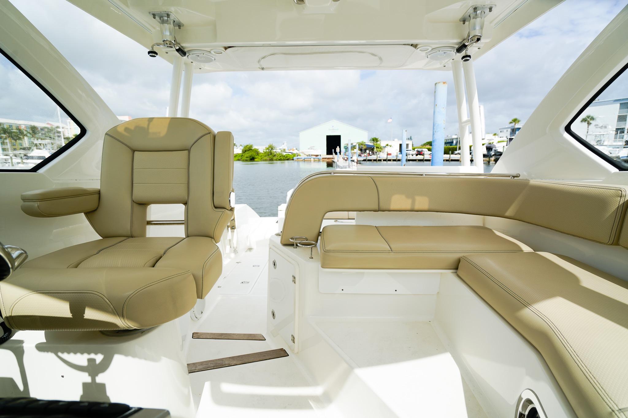 2020 Pursuit OS 325 Offshore boat interior with beige seating and waterfront view.