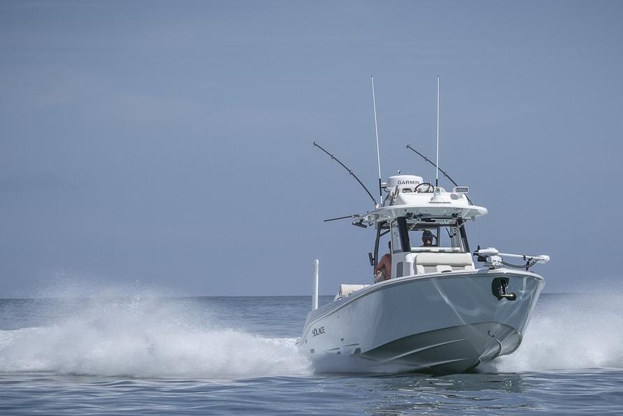 Manufacturer Provided Image: 2026 Solace 30 HCS boat speeding on open water, creating a dynamic wake.