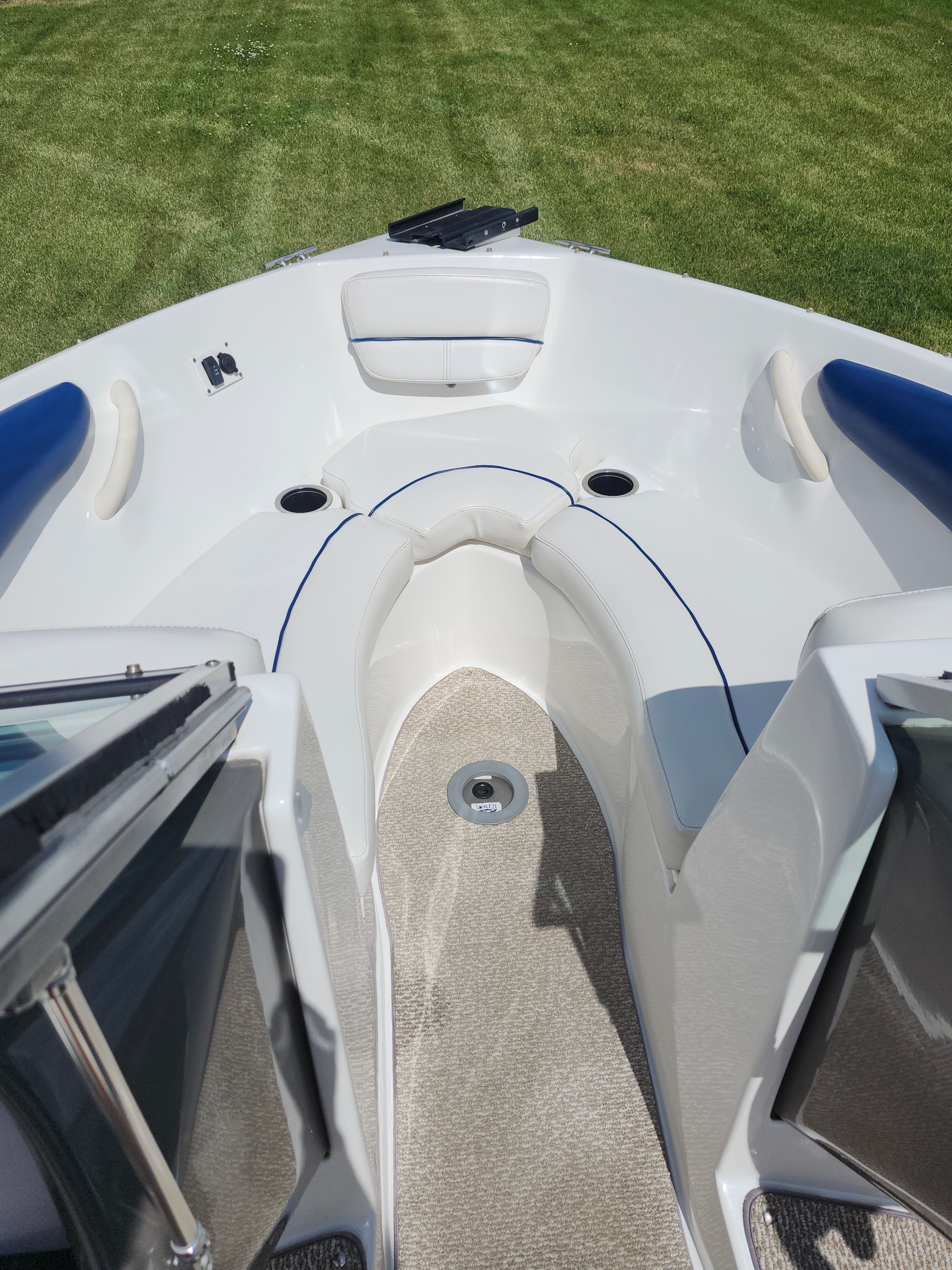 The image shows the bow of a Rinker 186 Captiva boat with seating and cup holders.
